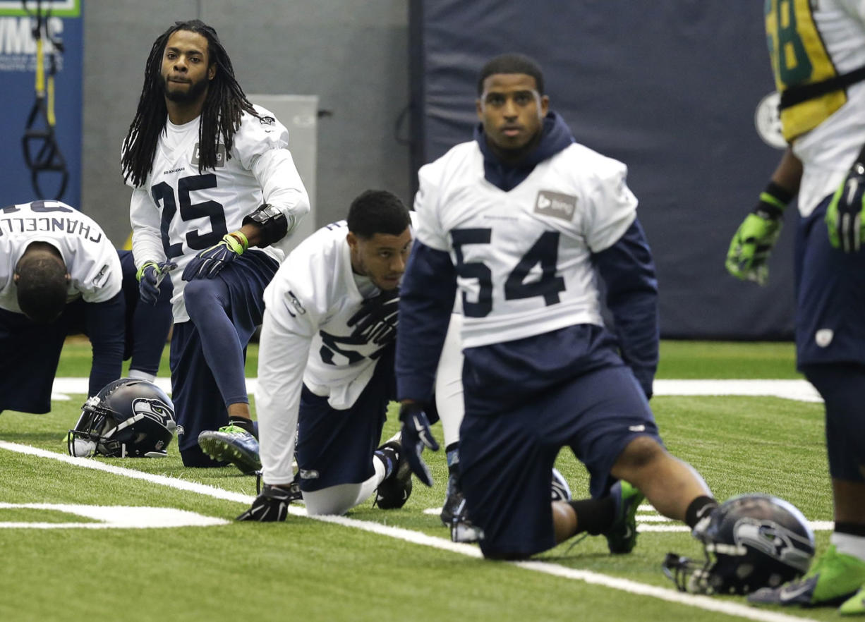 Seattle Seahawks cornerback Richard Sherman (25) and linebacker Bobby Wagner (54) stretch with other defensive players during practice, Friday, Jan. 23, 2015, in Renton, Wash. The Seahawks face the New England Patriots in Super Bowl XLIX on Sunday, Feb. 1, 2015, in Glendale, Ariz. (AP Photo/Ted S.