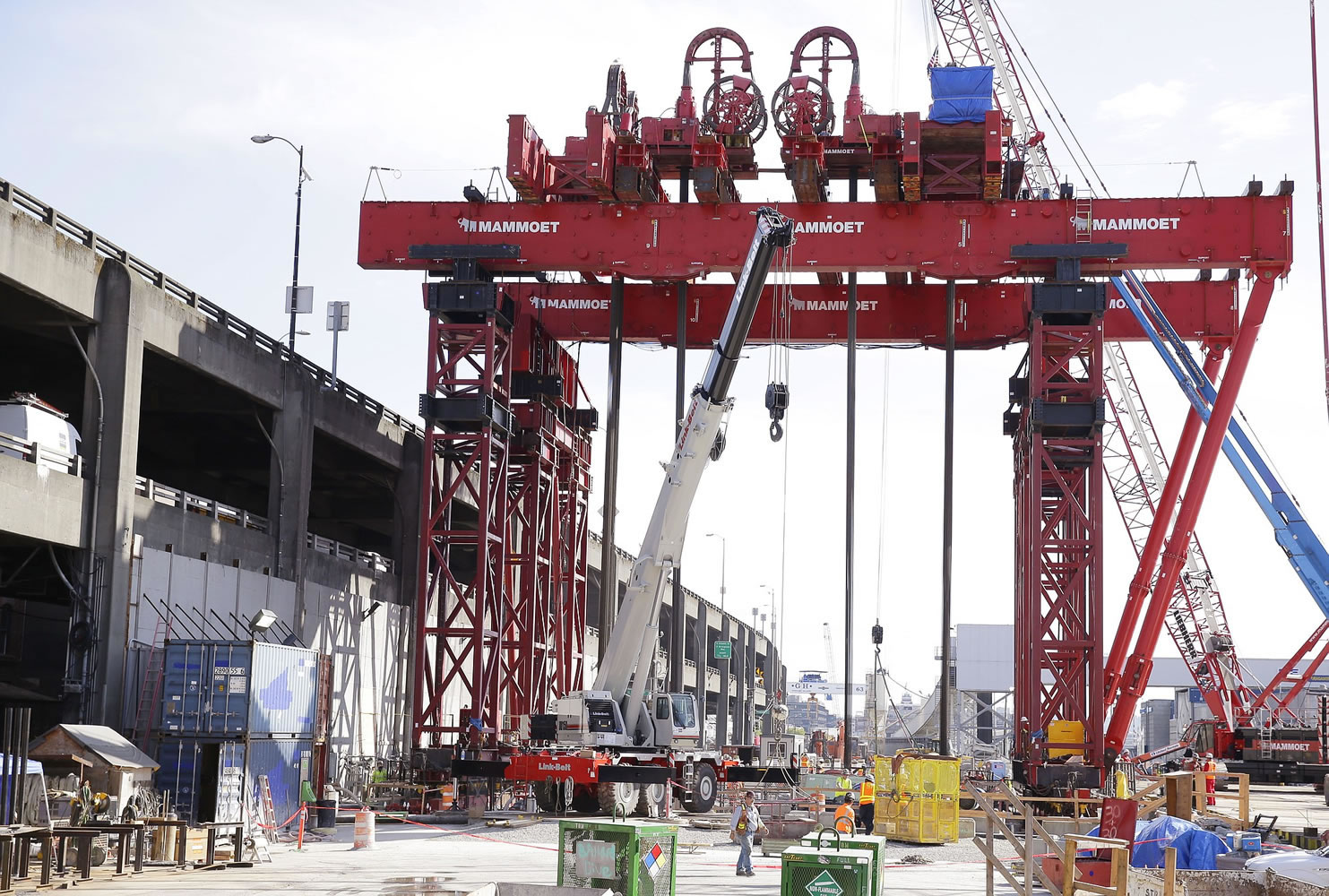 A massive crane is used Monday to lift a 2,000-ton section of the tunnel boring machine known as Bertha that is currently stalled underground and awaiting repairs in Seattleund to the machine.