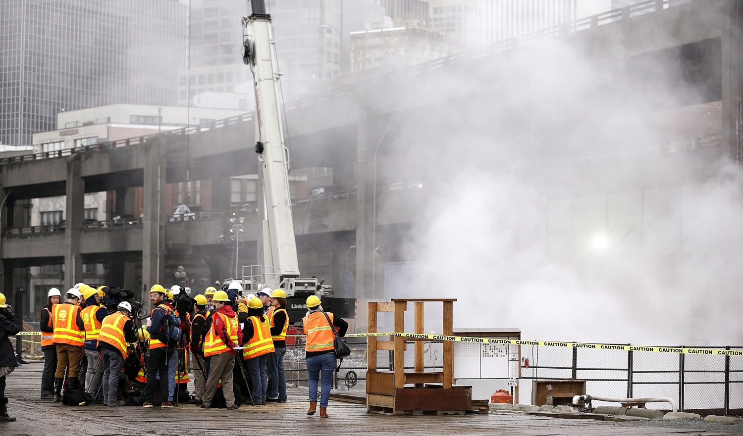 A cloud of concrete dust mixed with steam fills the air Thursday above an access pit for a damaged digging machine for the Highway 99 tunnel project in Seattle.