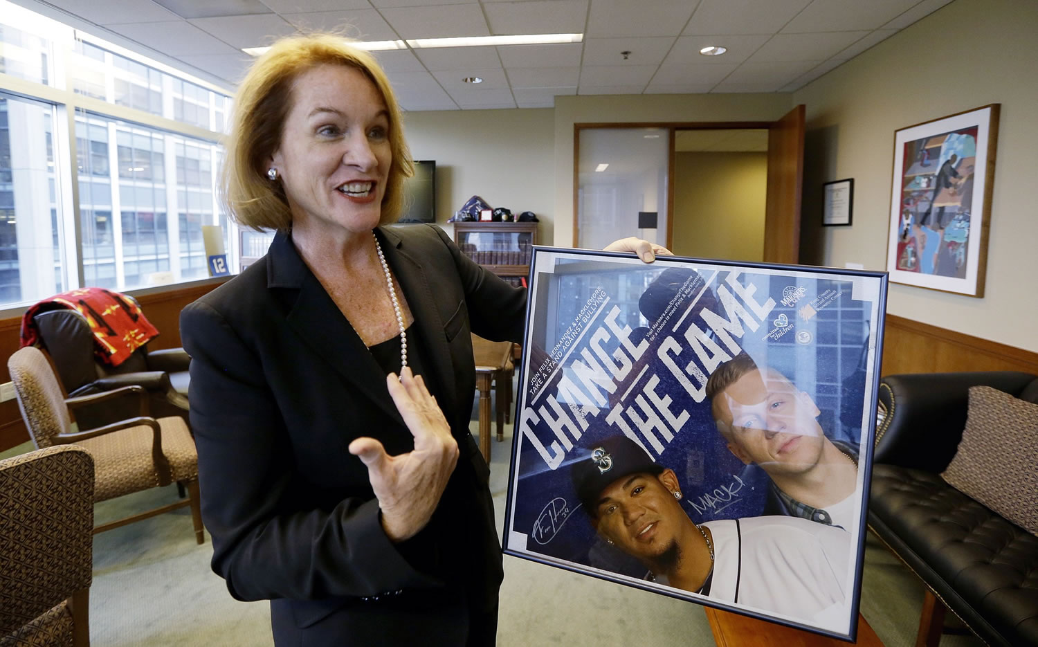 U.S Attorney for Western Washington Jenny Durkan holds memorabilia from an anti-bullying event she helped organize with the Seattle Mariners and rapper Macklemore as she stands in her office Sept. 29 in Seattle.