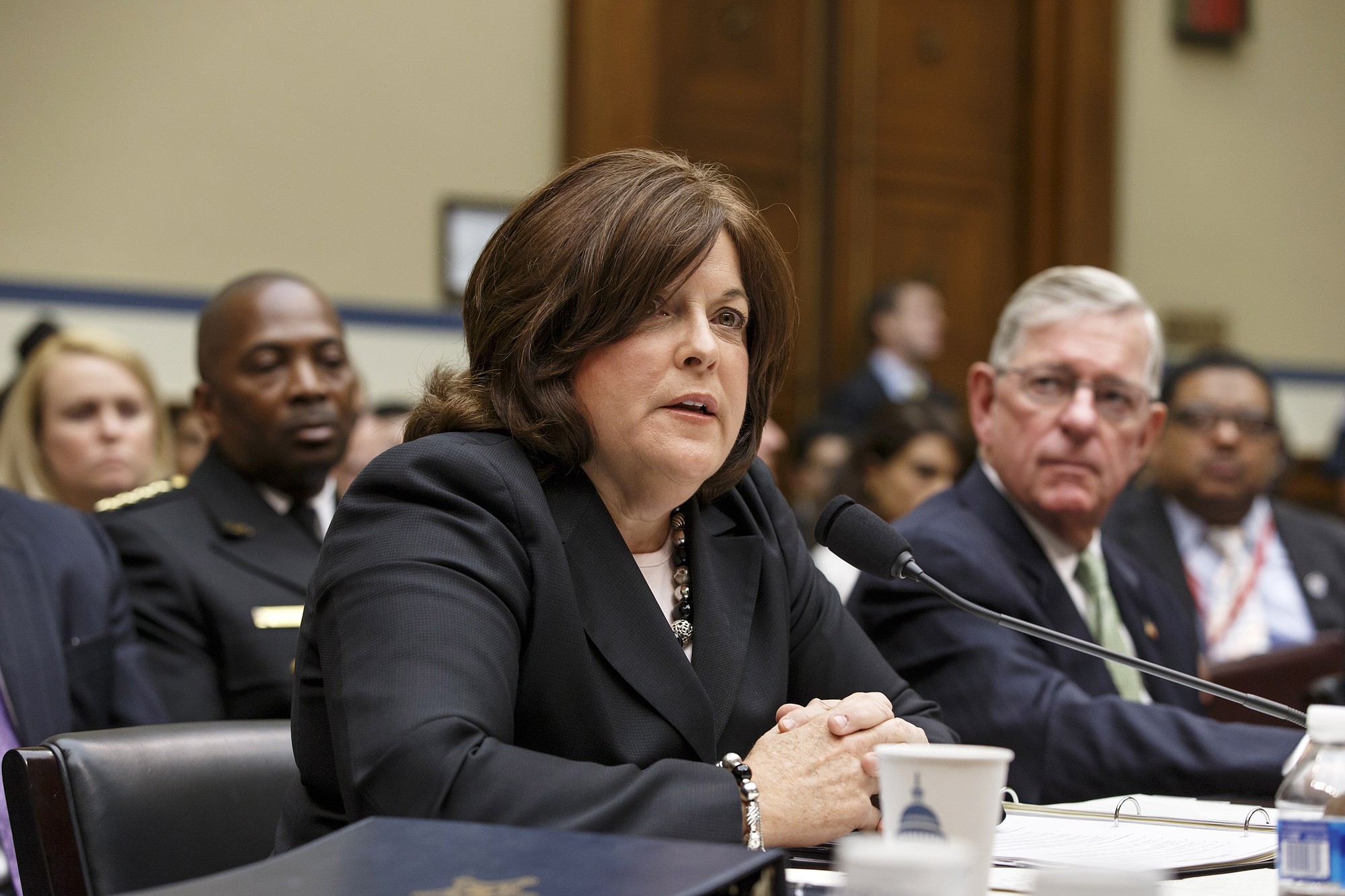 Secret Service Director Julia Pierson, left, joined by Ralph Basham, a former Secret Service director, testifies on Capitol Hill in Washington on Tuesday in front of the House Oversight Committee as it examines details surrounding a security breach at the White House when a man climbed over a fence, sprinted across the north lawn and dash deep into the executive mansion before finally being subdued.