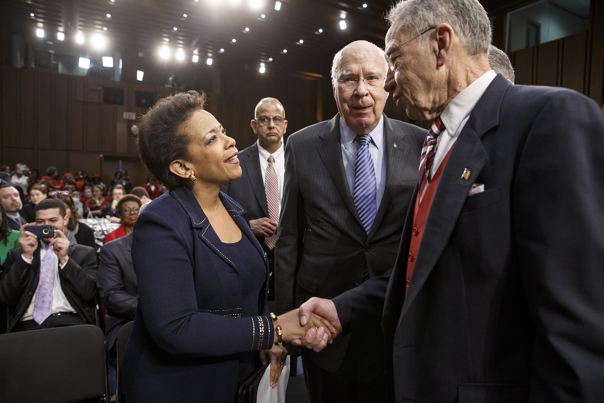 Senate Judiciary Committee Chairman Sen. Charles Grassley, R-Iowa, right, accompanied by the committee's ranking member, Sen. Patrick Leahy, D-Vt., center, greets Attorney general nominee Loretta Lynch on Capitol Hill in Washington in January before the start of her confirmation hearing before the committee.