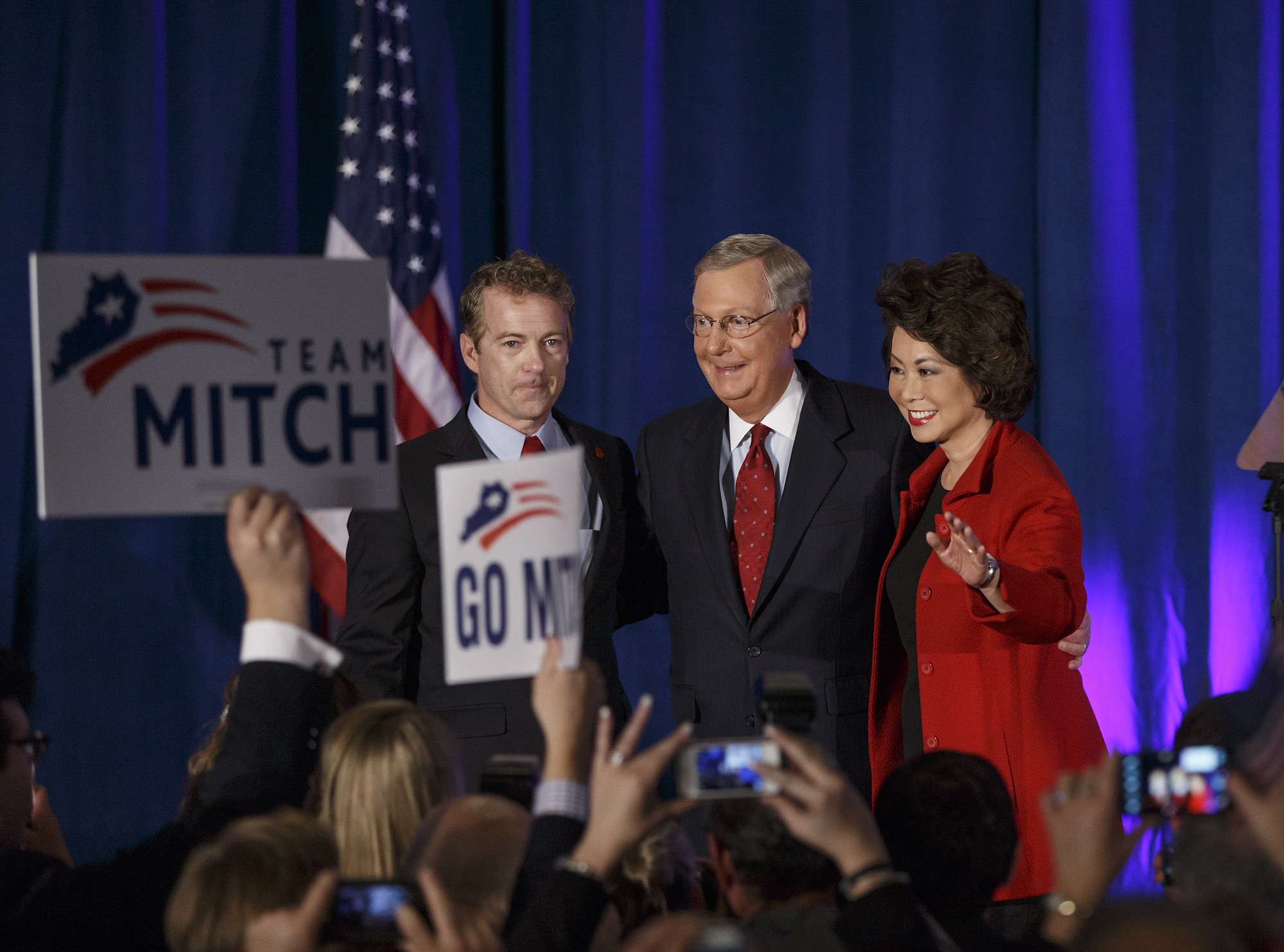 Senate Minority Leader Mitch McConnell, R-Ky., center, celebrates Tuesday with Sen. Rand Paul, R-Ky., left, and his wife, former Labor Secretary Elaine Chao, at an election night party in Louisville, Ky.. McConnell won a sixth term in Washington, with his eyes on the larger prize of GOP control of the Senate. . (AP Photo/J.