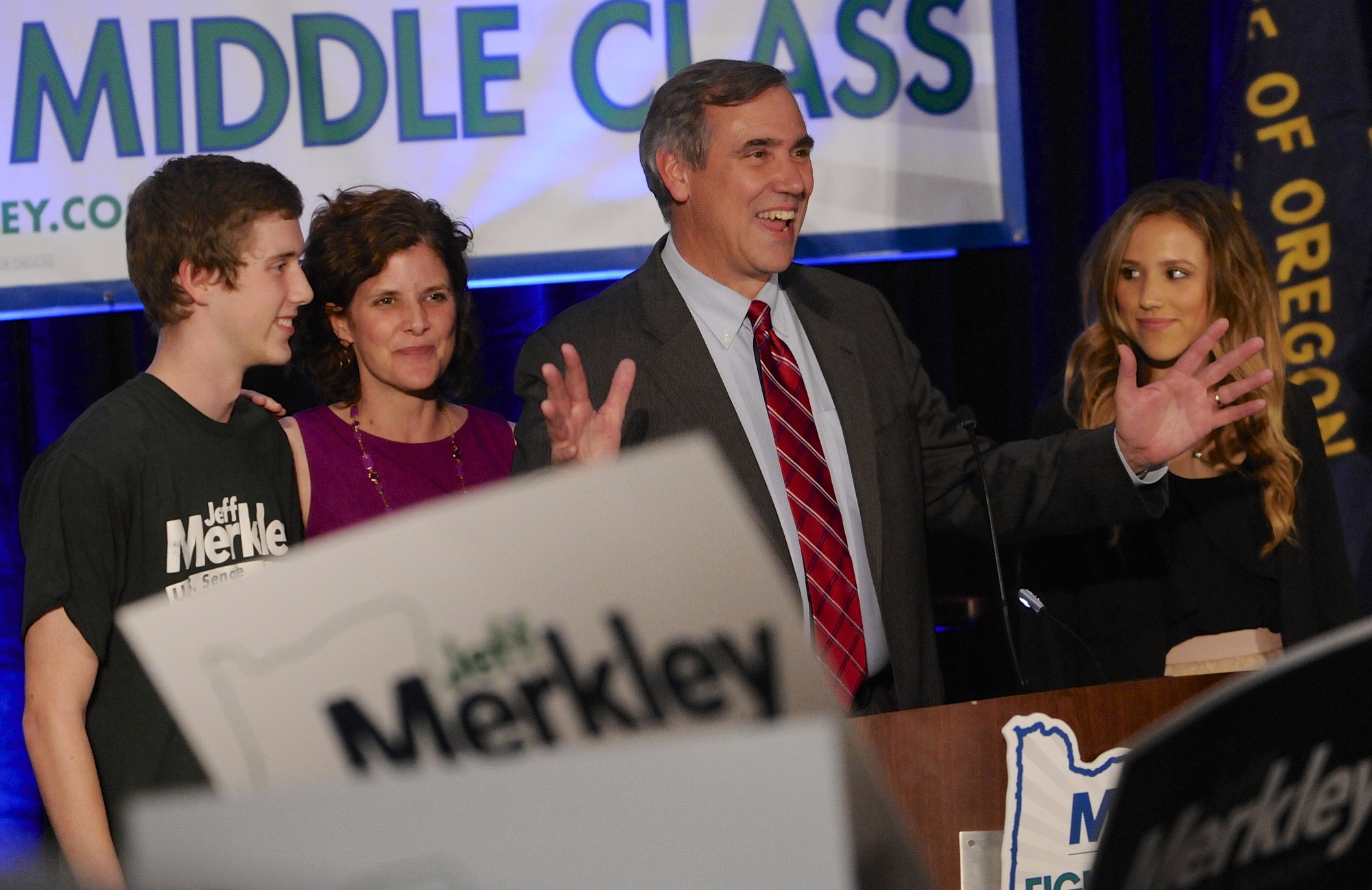 Sen. Jeff Merkley, D-Ore., center, with, from left, son Jonathan Merkely, wife Mary and daughter Brynne Merkely, greets supporters at the Democratic election night party in Portland on Tuesday. Merkley was re-elected to the U.S. Senate.