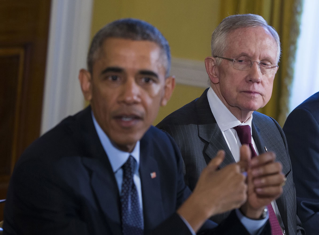 Senate Majority Leader Harry Reid of Nev., right, listens as President Barack Obama speaks during a meeting Nov. 7, 2014, with Congressional leaders in the Old Family Dining Room of the White House in Washington. Reid is announcing he will not seek re-election to another term.