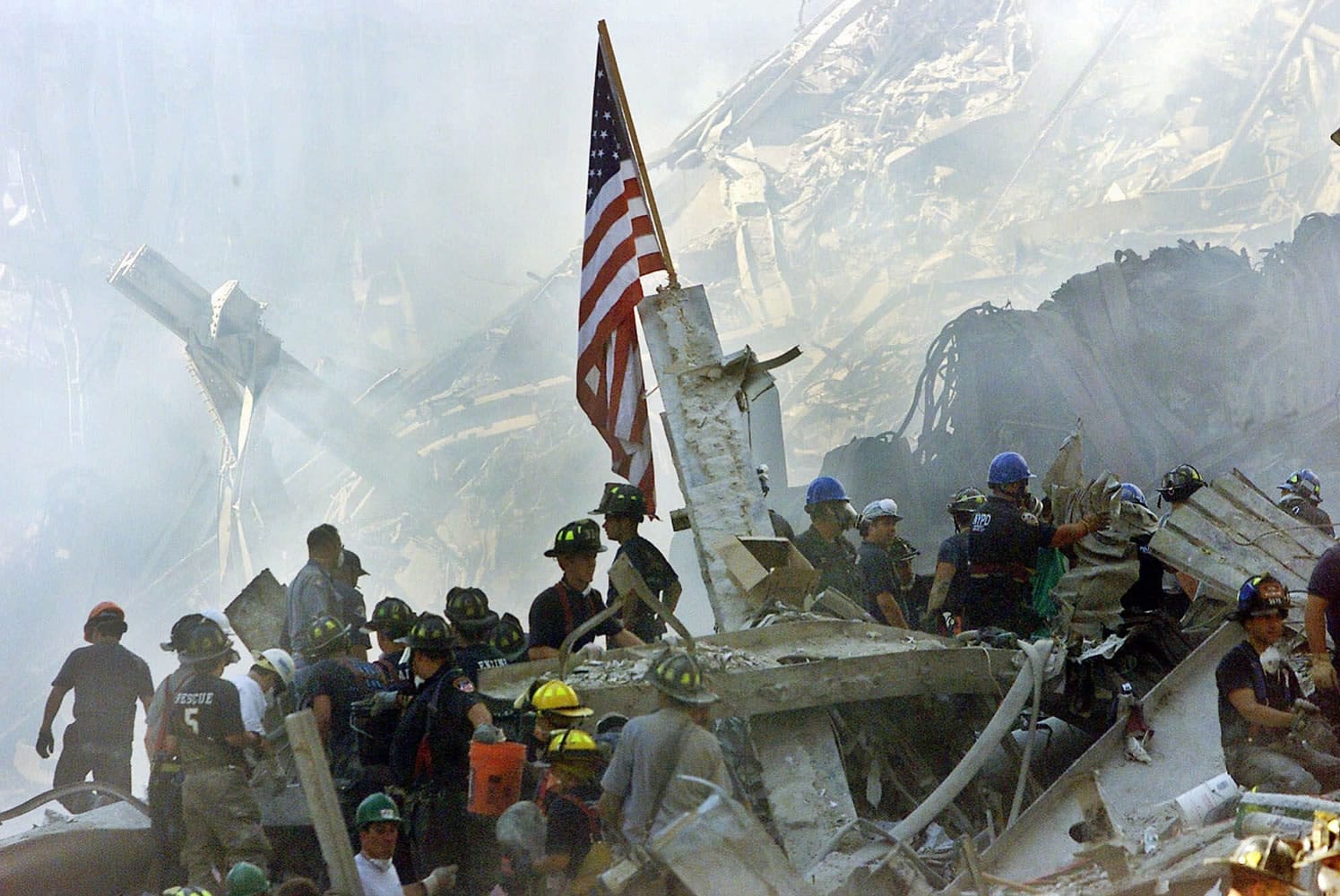 An American flag flies Sept. 13, 2001, at Ground Zero over the rubble of the collapsed World Trade Center buildings in New York. For years, a handful of current and former American officials have been urging President Barrack Obama to release secret files that they believe document links between the government of Saudi Arabia and the terrorist attacks of Sept. 11, 2001.