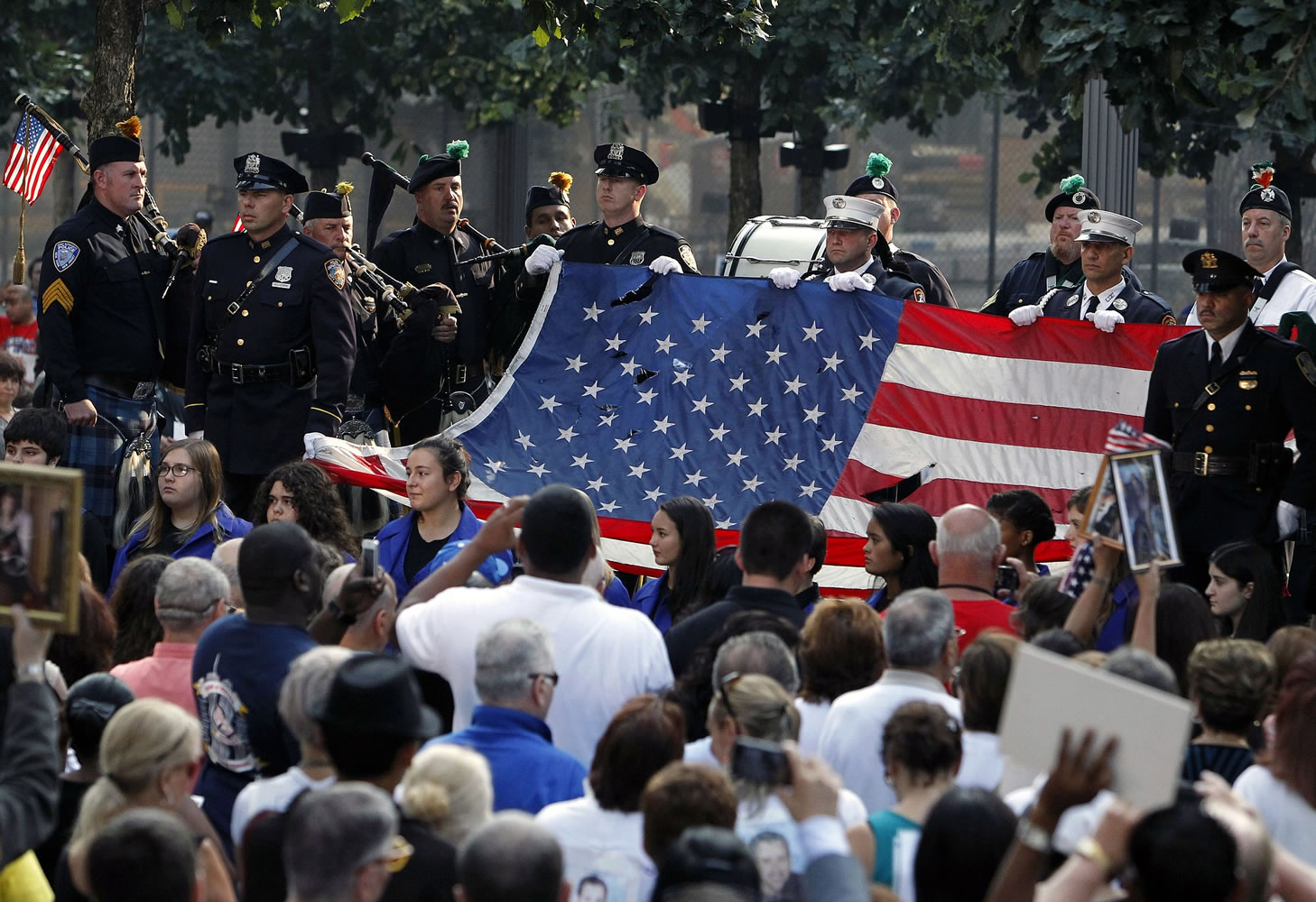 The World Trade Center Flag is presented as friends and relatives of the victims of the 9/11 terrorist attacks gather at the National September 11 Memorial at the World Trade Center site Wednesday for a ceremony marking the 12th anniversary of the attacks in New York.