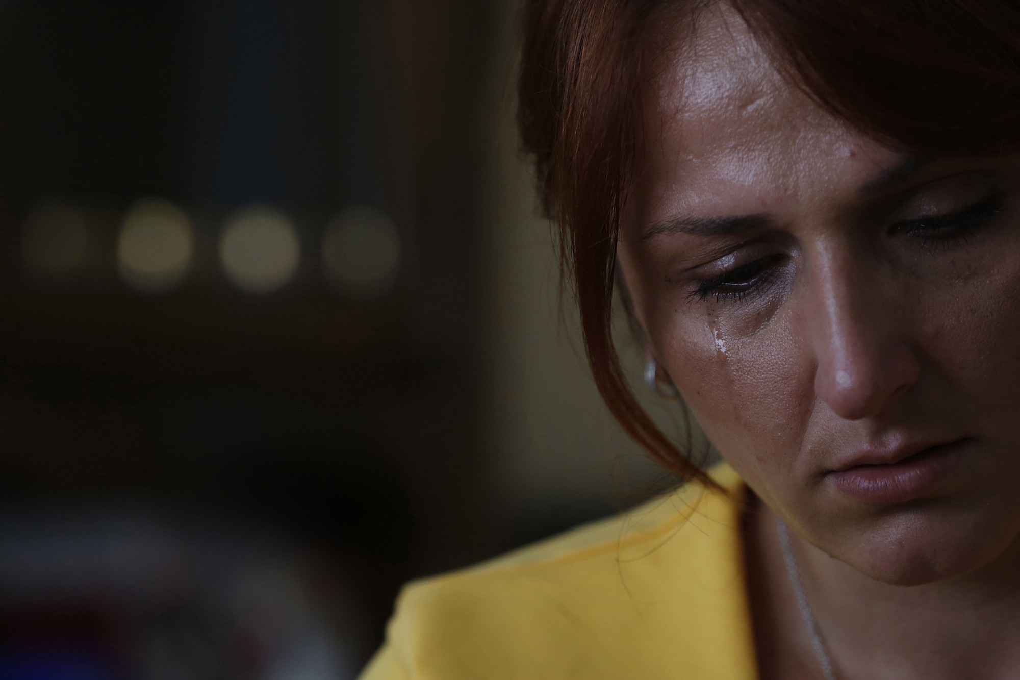 Selma Colovic-Memovic, the daughter of Fikret Memovic, cries in July while she looks at photographs of her father, a railway worker from southwest Serbia who was traveling home from Belgrade when he and 18 others were snatched off a train at the height of the Balkans conflict and killed by Bosnian Serbs.