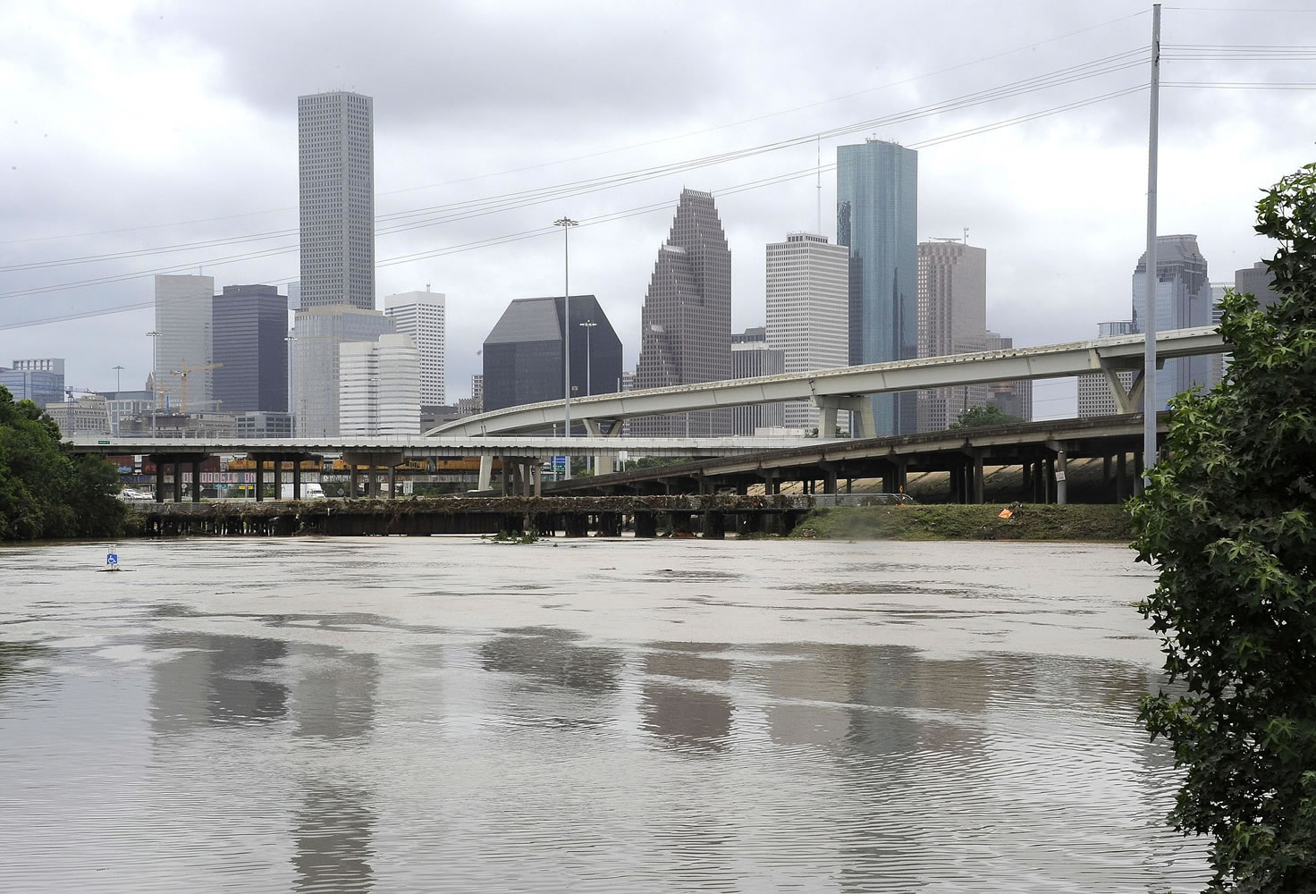 Flood waters overrun the banks of the bayou in downtown Houston, on Tuesday.