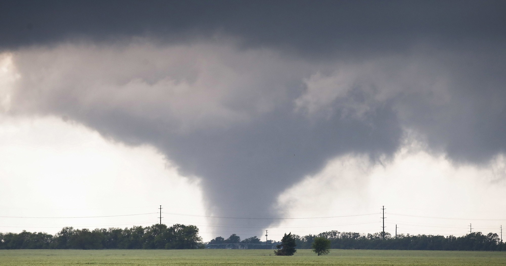 A large tornado passes just to the west of the city of Halstead, Kan., Wednesday, May 6, 2015. A swath of the Great Plains is under a tornado watch Wednesday, including parts of North Texas, Oklahoma, Kansas and Nebraska.