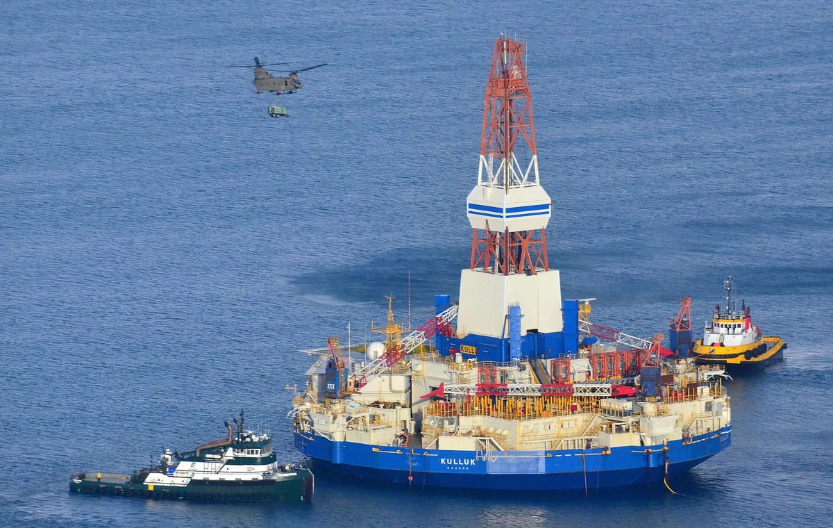 A U.S. Army CH-47 Chinook helicopter flies over the Kulluk, the Shell floating drill rig off Kodiak Island in Alaska's Kiliuda Bay, as salvage teams conduct an in-depth assessment of its seaworthiness.