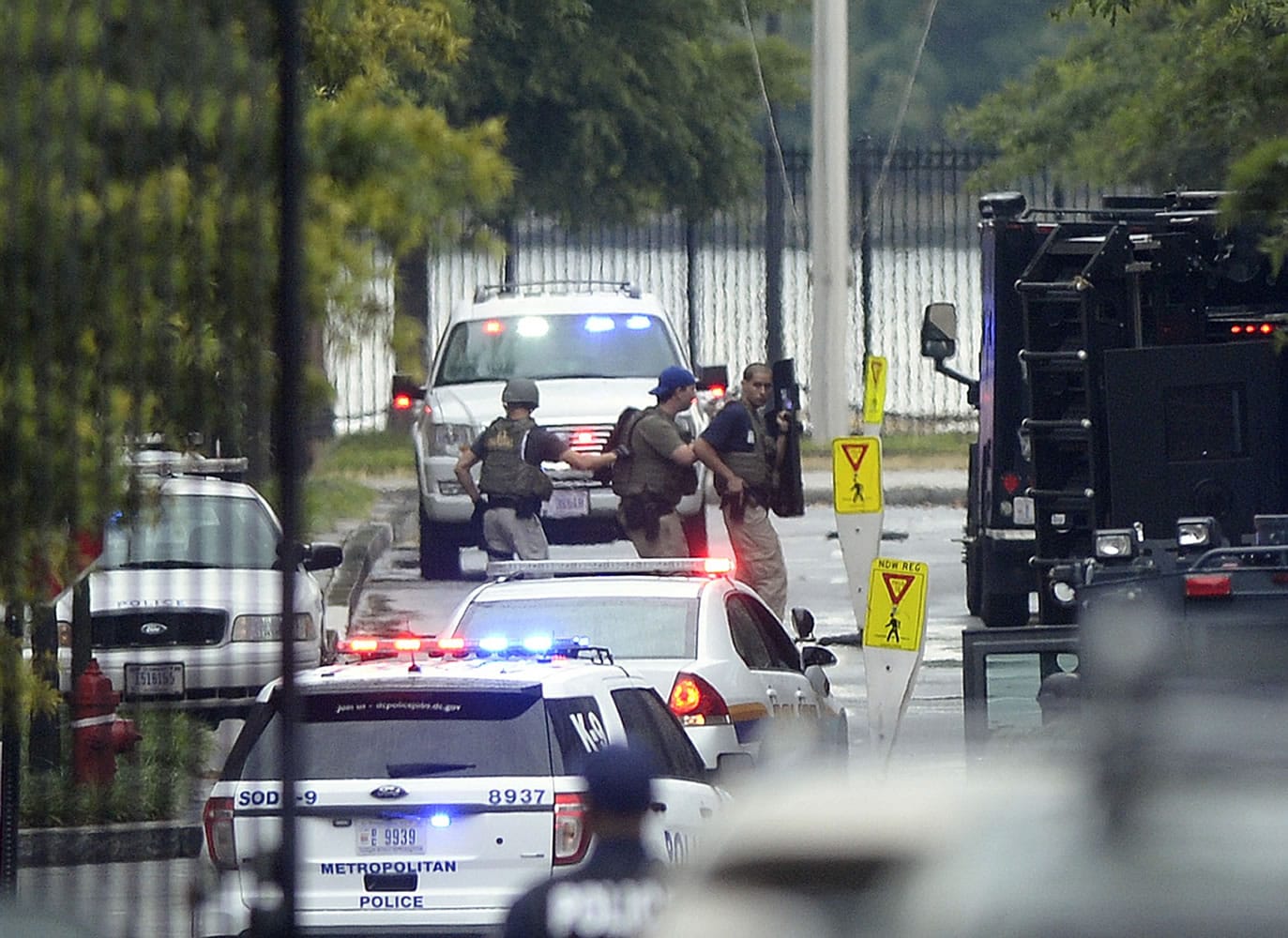 Law enforcement personnel are seen through the gate into the Washington Navy Yard in Washington on Monday.