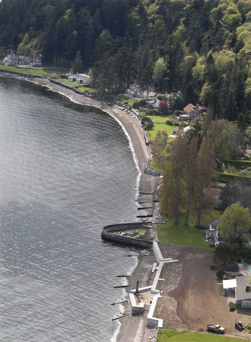 This May 1, 2008, photo shows the Bulkheads along Puget Sound, protecting expensive homes on the south end of Bainbridge Island, Wash.  Three conservation groups on Wednesday, June 24, 2015, petitioned the U.S. Army Corps of Engineers to change how it regulates seawalls, bulkheads or other barriers to increase habitat protections along Puget Sound shorelines.