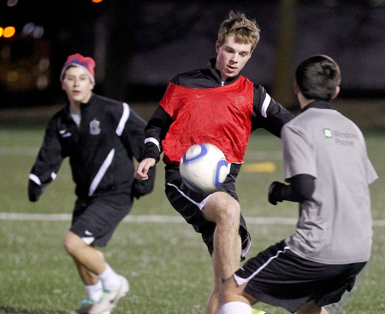Sam Schneider, left, practices with his U16-9798 Premiere club soccer team at St. Louis Soccer Park in St.