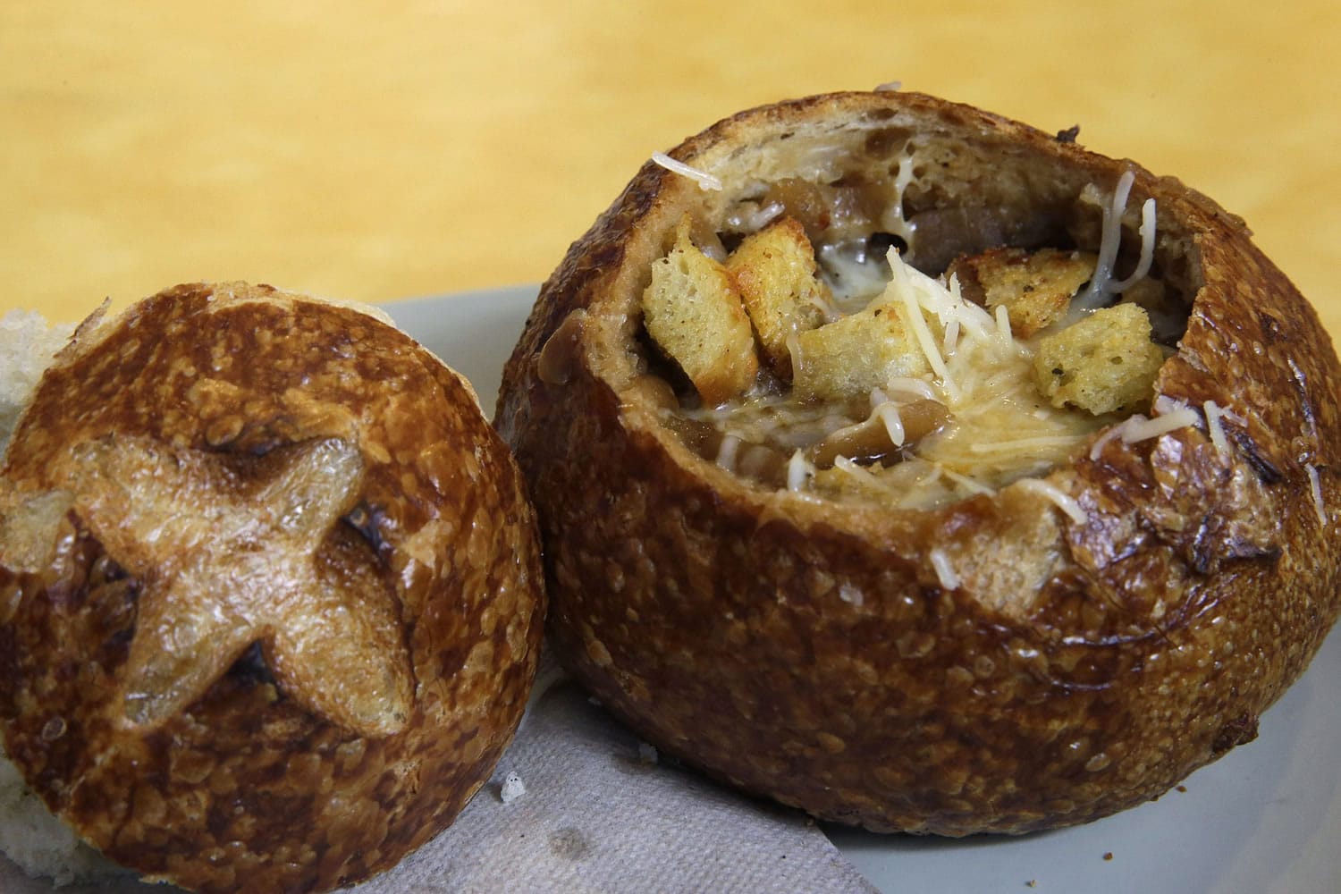A Bistro French Onion Soup Bread Bowl is seen at a Panera bread restaurant, Tuesday, June 9, 2015, in New York. New York City could become the first city in the U.S. to require a warning label on high-sodium menu items at chain restaurants, health officials told The Associated Press on Tuesday. A Bistro French Onion Soup Bread Bowl contains more sodium than the recommended daily limit of 2,300 milligrams, which is equal to about 1 teaspoon of salt.