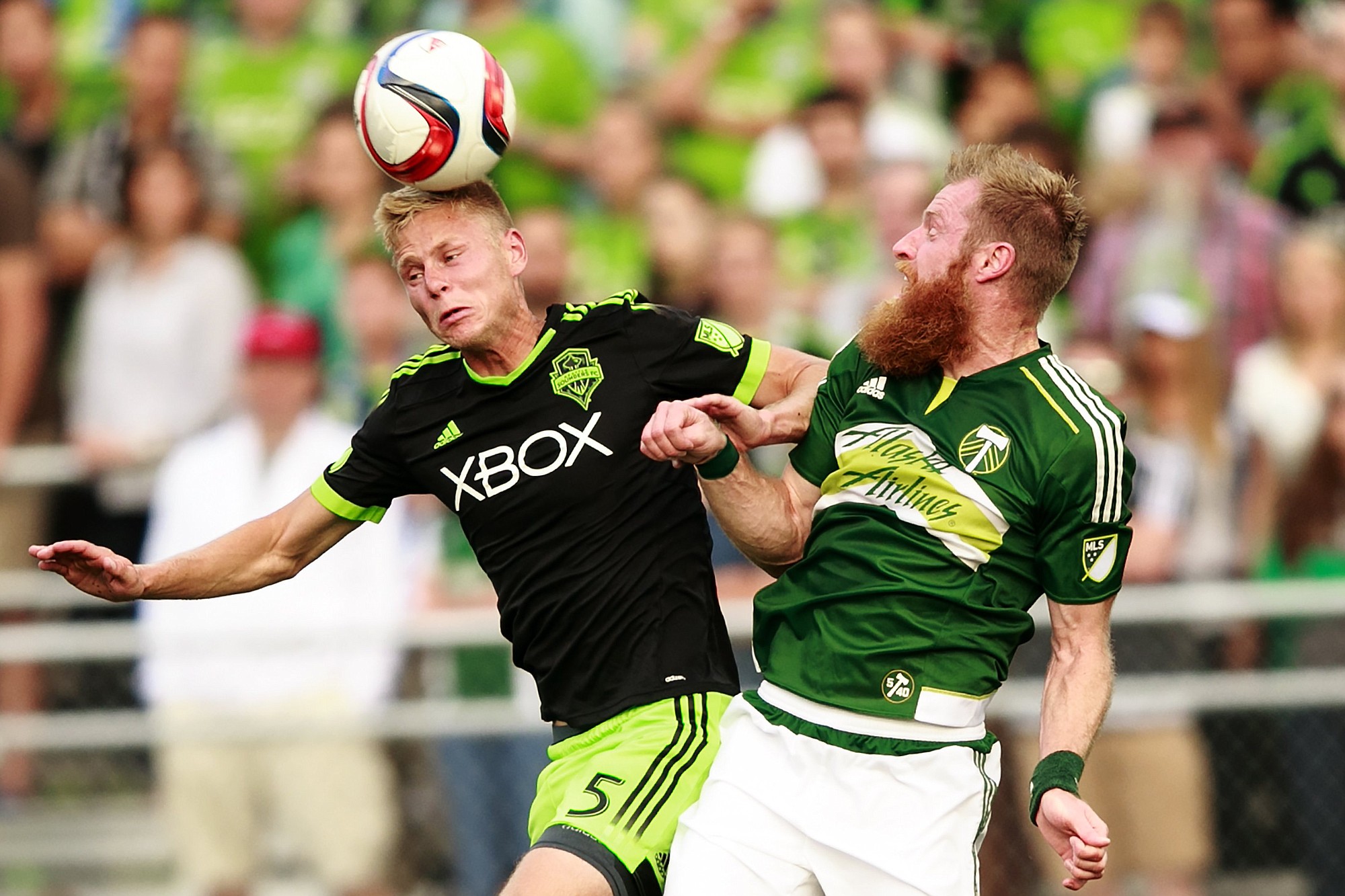 Seattle midfielder Andy Rose (5) heads the ball against Portland defender Nat Borchers Tuesday.