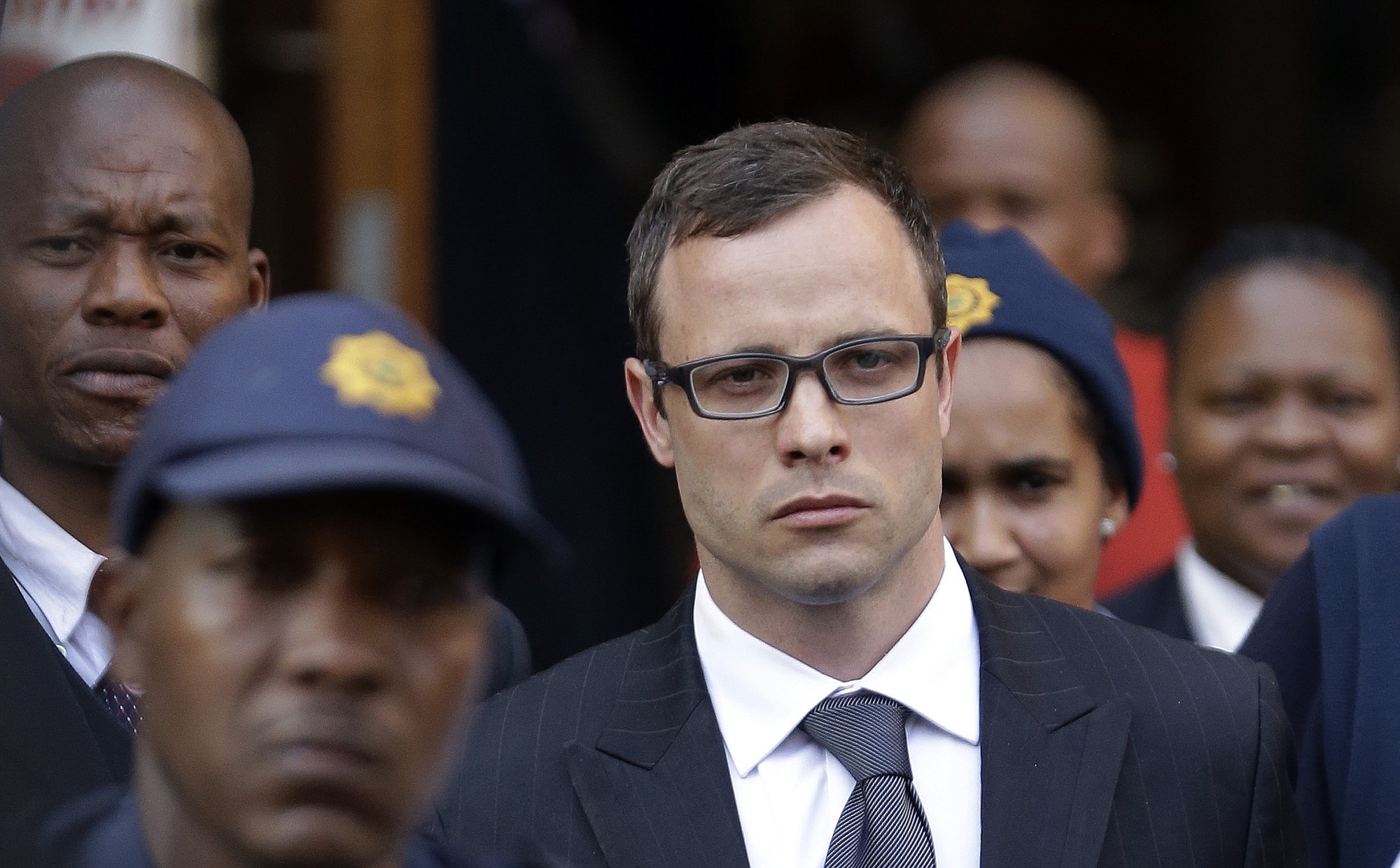 Oscar Pistorius, center, leaves the high court in Pretoria, South Africa, on Thursday.