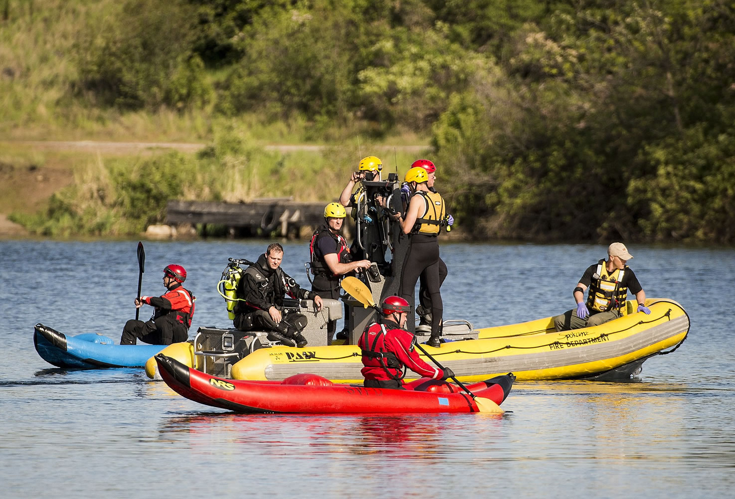 The Spokane County Sheriff's dive team and other emergency personnel search the Spokane River on Thursday near where a small plane crashed.