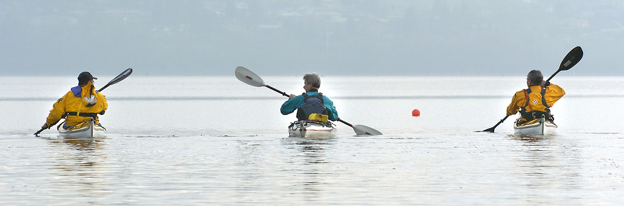 2/28/04-Vancouver, WA--L-R--Norm Sharp, Frank Klejmont and John Hren, all from Portland, paddle their kayaks across a calm Vancouver Lake Saturday morning.(Steven Lane/The Columbian)