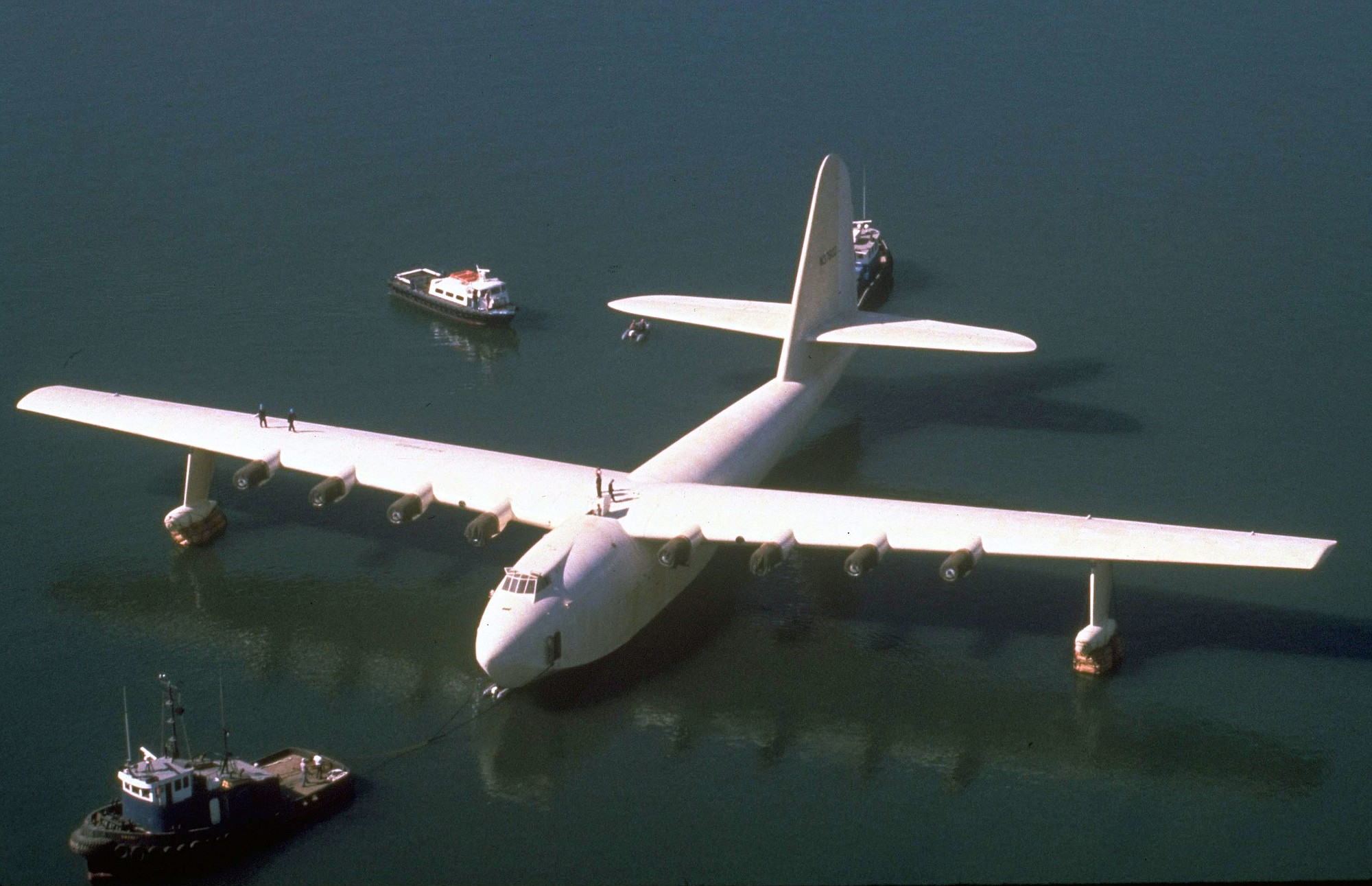 FILE - In this Oct. 29, 1980 file photo, Howard Hughes' wooden flying boat the &quot;Spruce Goose,&quot; is towed by a tugboat from its hangar in Long Beach, Calif. The gigantic historic wooden airplane whose fate was mired in a financial dispute, will permanently stay in Oregon. The Evergreen Aviation and Space Museum has reached an agreement with the Aero Club of Southern California to take full ownership of the plane in the coming weeks, said California attorney Robert E. Lyon, who represents the Aero Club. Lyon said the agreement was reached in early July 2015.