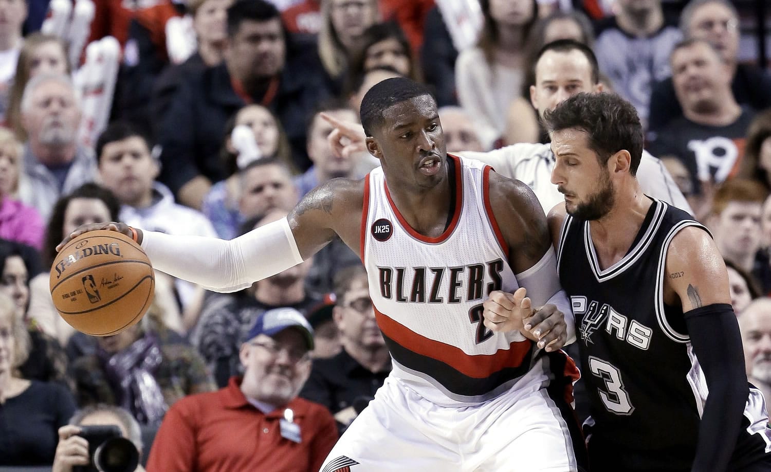 Portland Trail Blazers guard Wesley Matthews, left, works the ball in on San Antonio Spurs guard Marco Belinelli during the second half of an NBA basketball game in Portland, Ore., Wednesday, Feb. 25, 2015.  Matthews led the Trail Blazers in scoring with 31 points as Portland won 111-95.