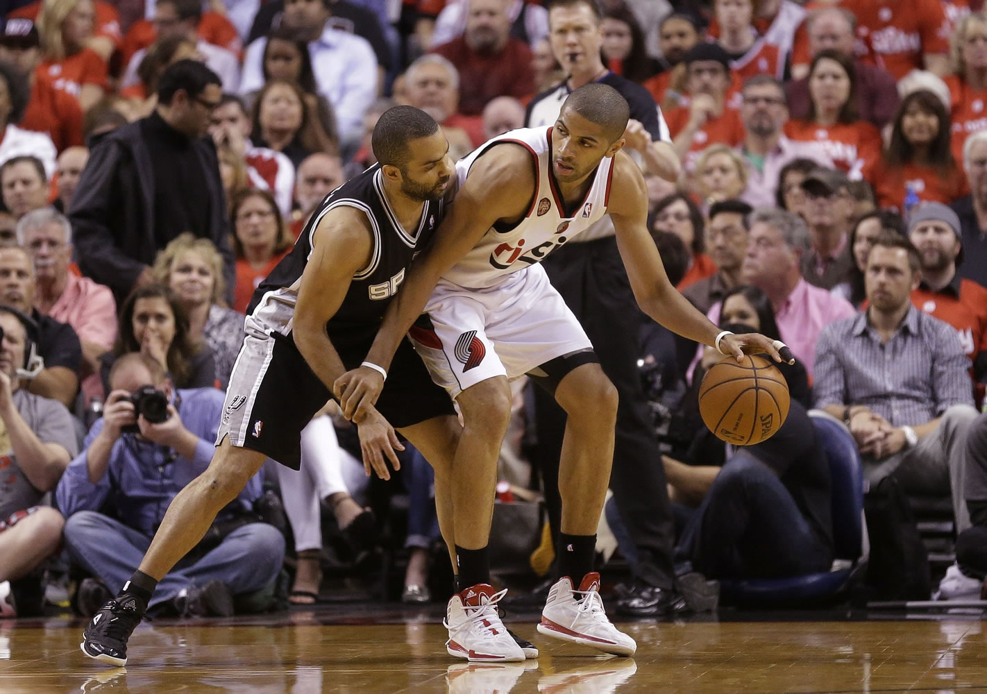 The Spurs' Tony Parker, left, guards the Blazers' Nicolas Batum, in the first quarter during the playoffs last season.