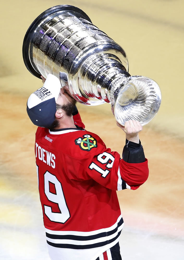 Chicago Blackhawks' Jonathan Toews kisses the Stanley Cup trophy after defeating the Tampa Bay Lightning in Game 6 of the NHL Stanley Cup Final on Wednesday, June 10, 2015, in Chicago. The Blackhawks defeated the Lightning 2-0 to win the series 4-2.