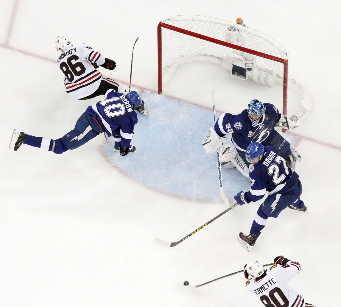 Chicago Blackhawks center Antoine Vermette (80) shoots to score against the Tampa Bay Lightning during the third period of Game 5 of the NHL Stanley Cup Final, Saturday, June 13, 2015, in Tampa, Fla.
