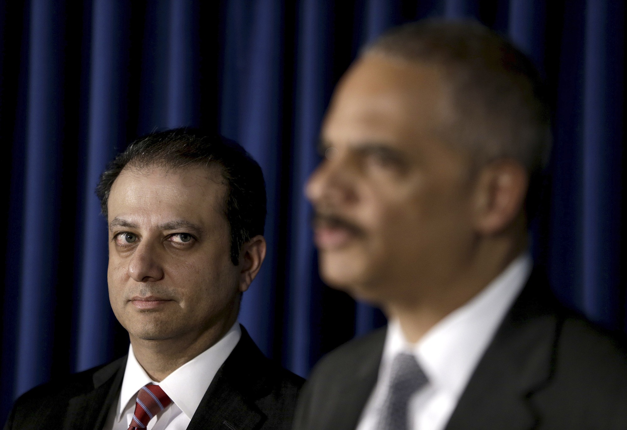 U.S. Attorney for the Southern District of New York Preet Bharara, left, looks on as U.S.