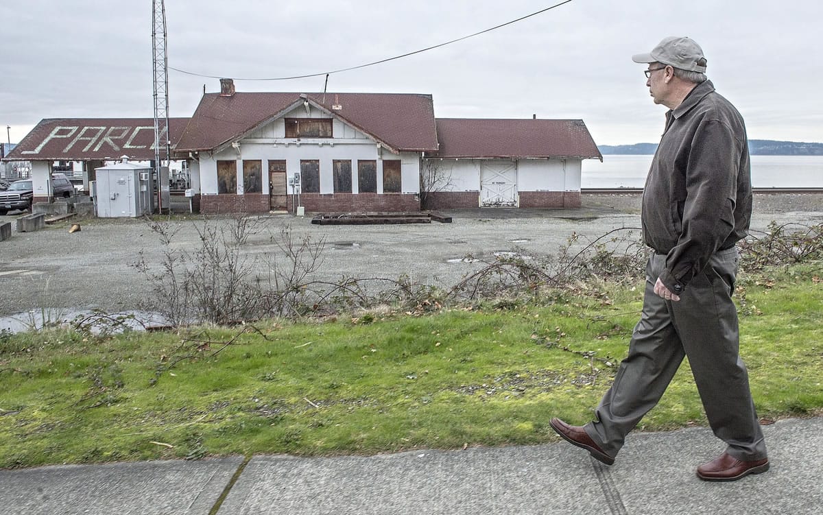 Train buff Bob Hollister of Steilacoom walks past the 100-year-old rail depot on the waterfront in Steilacoom.