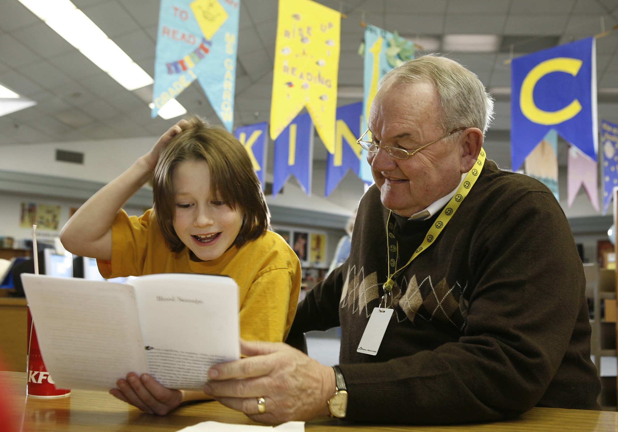 Seth Hunt, then a fifth-grader at Martin Luther King Elementary School in Vancouver, reads a passage from &quot;Blood Sausage,&quot; a story by Patrick McManus, in February 2008 with Steve Runyan, a Lunch Buddy volunteer. The two had been lunch buddies since Seth was in third grade.