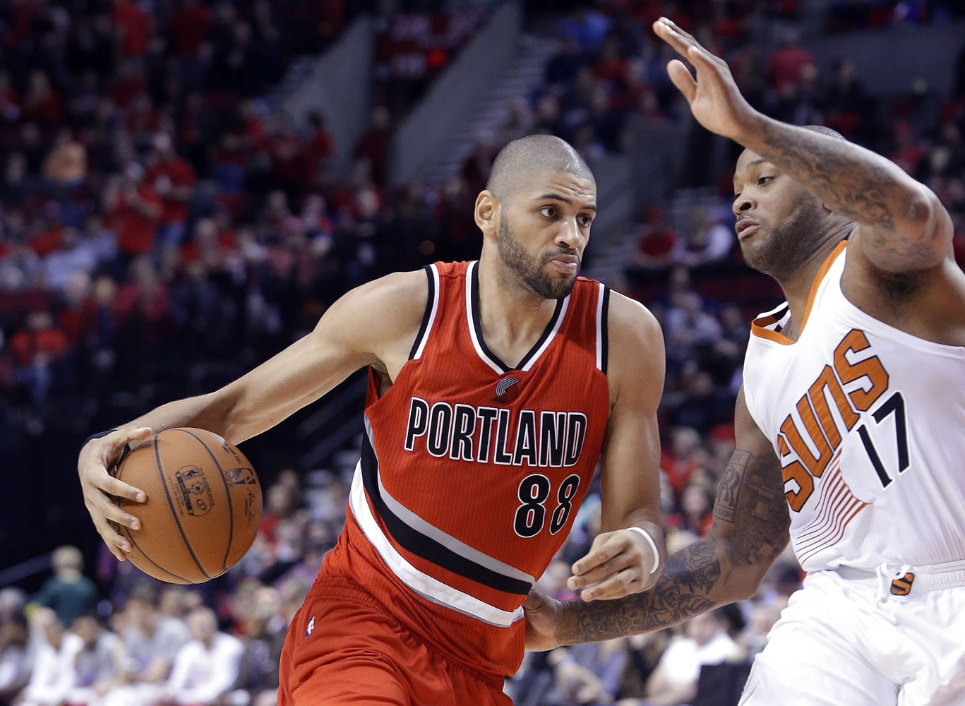 Portland's Nicolas Batum drives on Phoenix Suns forward P.J. Tucker during the second half Thursday. Batum topped the Trail Blazers with 20 points to go with seven assists as they defeated the Suns 108-87.