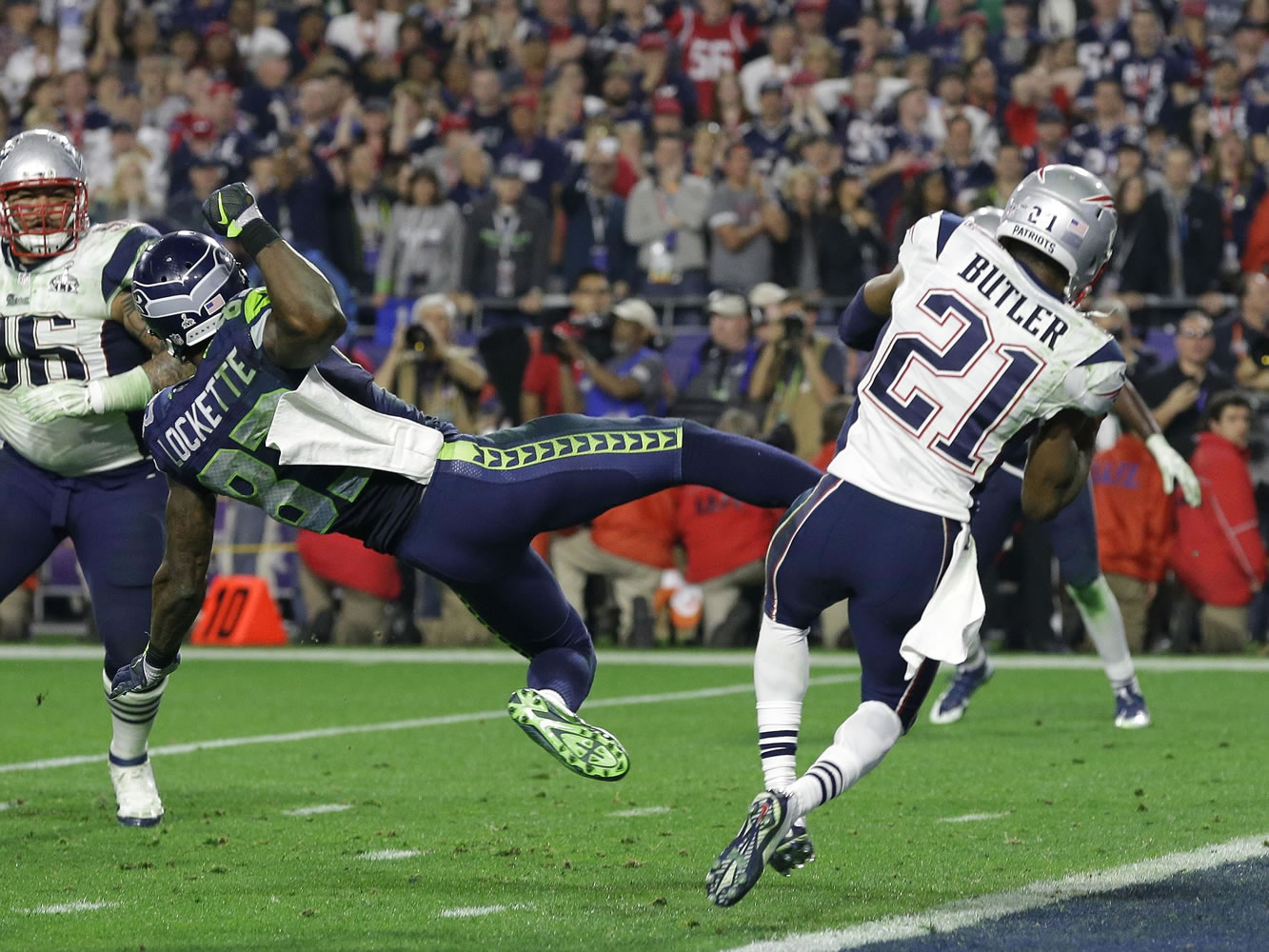 New England's Malcolm Butler (21) intercepts a pass in front of Seattle's Ricardo Lockette (83) in the closing seconds of Super Bowl XLIX on Sunday, sealing the Patriots' 28-24 victory.