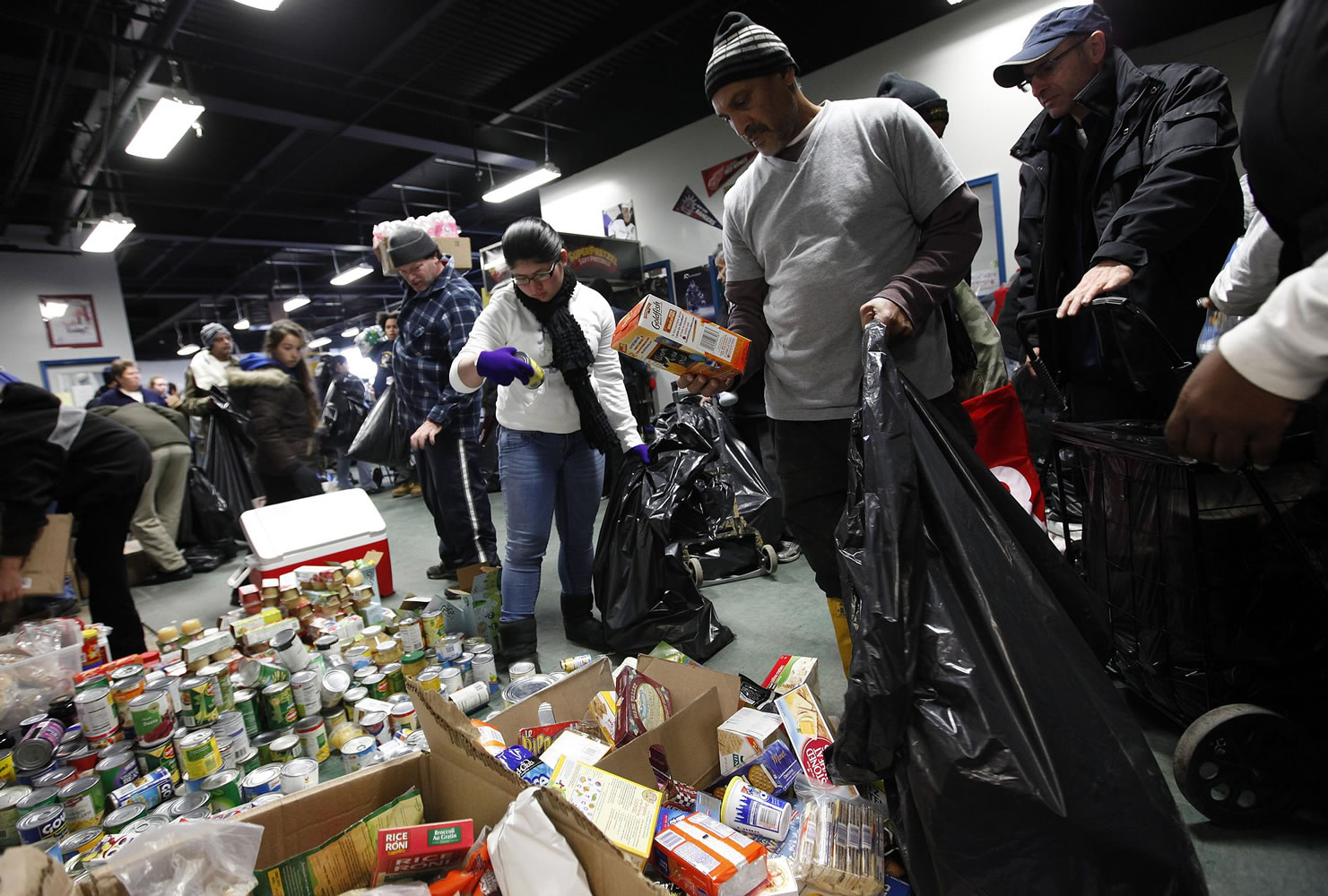 Storm victims browse through donated food items in November 2012 at a clothing and food distribution center in Long Beach, N.Y.