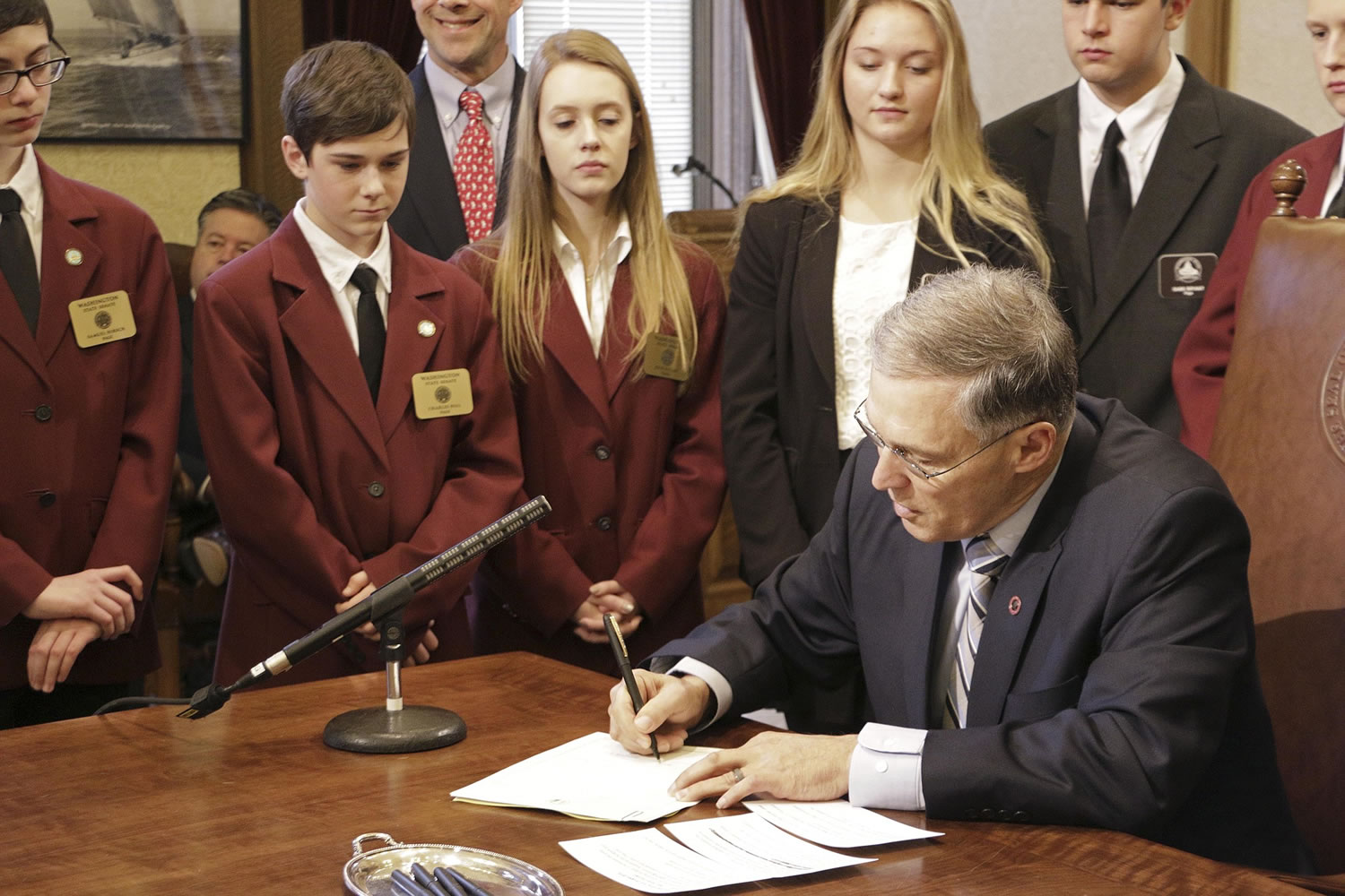 Gov. Jay Inslee signs a supplemental budget Thursday in Olympia.