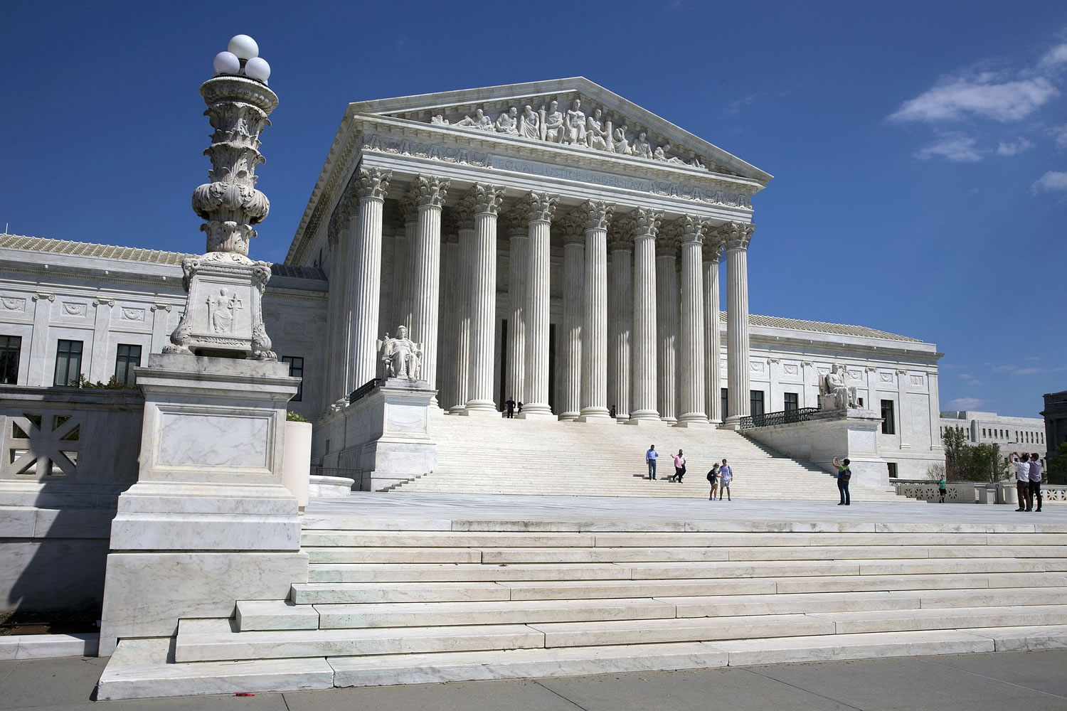 Associated Press files
People walk on the steps of the Supreme Court in Washington in April. The court announced Thursday the new cases it would consider during its 2014-15 term.