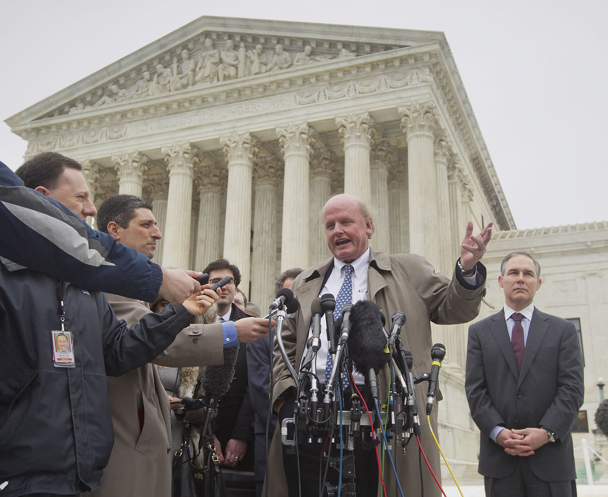 Michael Carvin, center, lead attorney for the petitioners, speaks to reporters outside the Supreme Court in Washington on Wednesday.