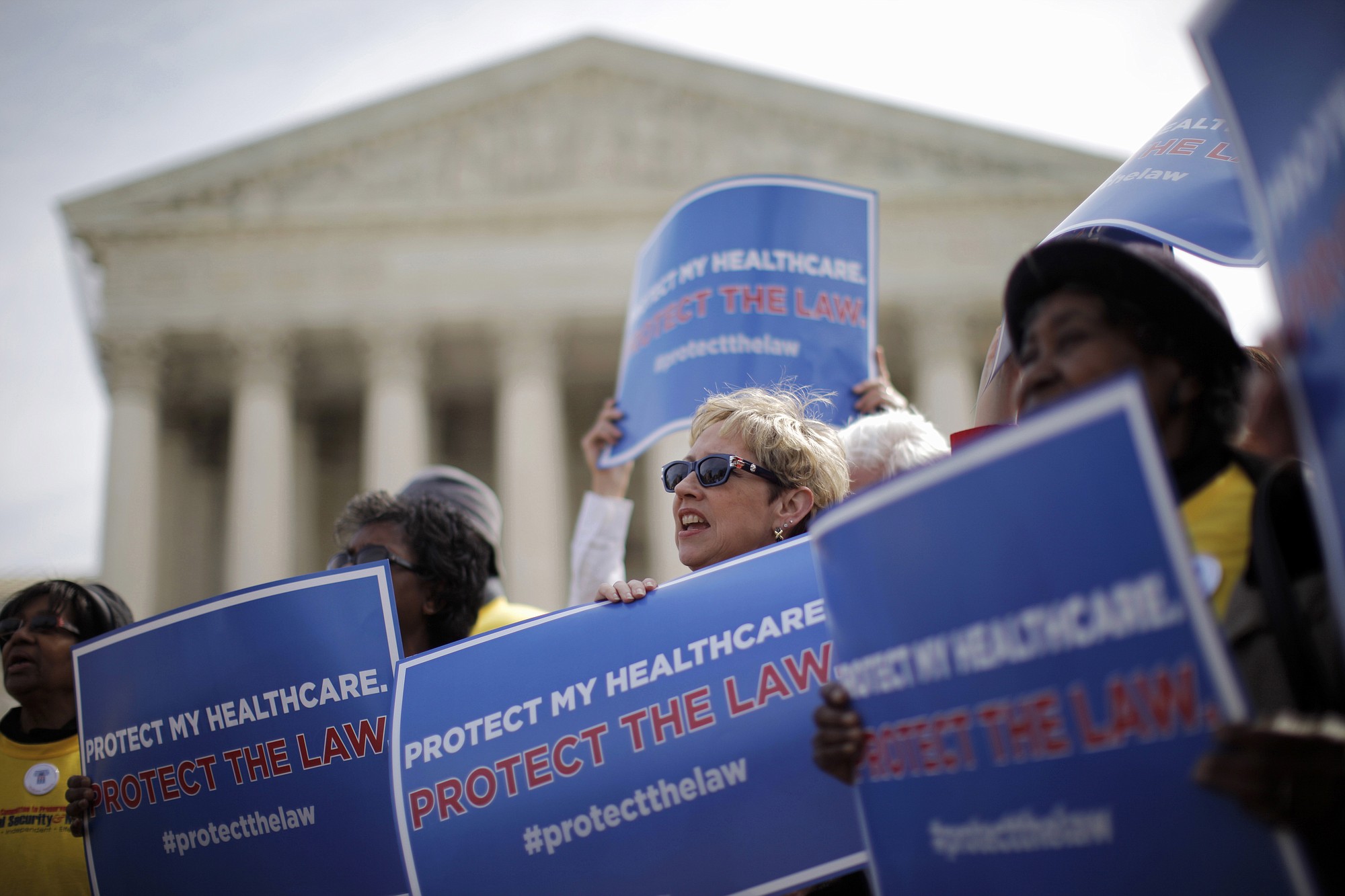 Supporters of health care reform rally in front of the Supreme Court in Washington