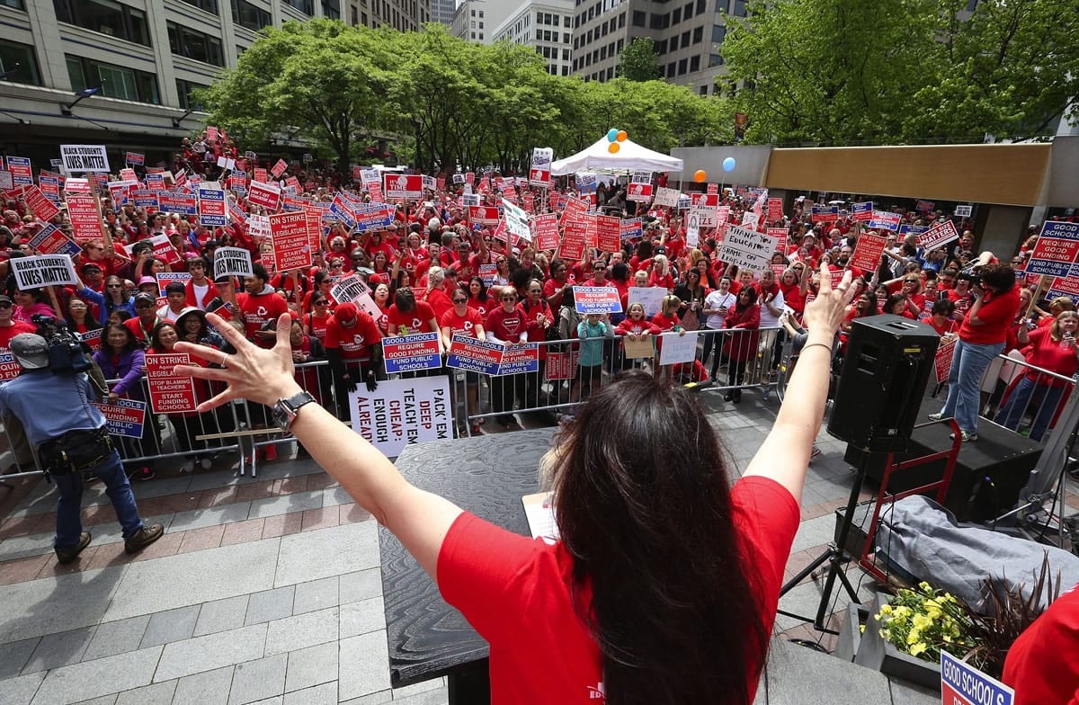 Seattle Education Association Vice President Phyllis Campano, center, rallies teachers from Seattle, Mercer Island and Issaquah school districts at Westlake Park on Tuesday in Seattle.