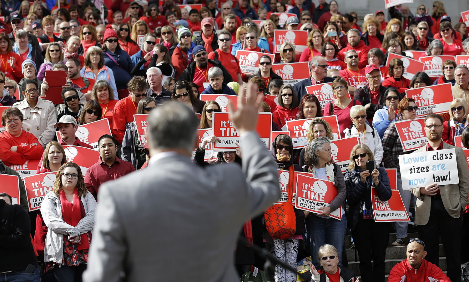 Washington Gov. Jay Inslee waves as he speaks to teachers and other education supporters during a Washington Education Association last month at the Capitol in Olympia.
