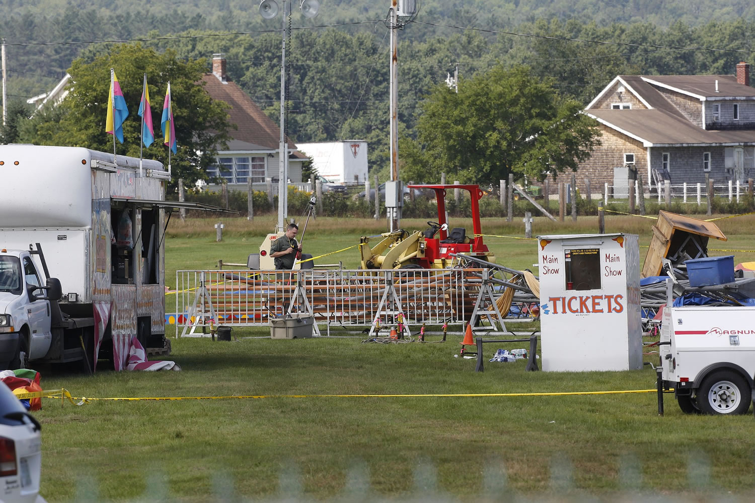 Investigators inspect the site of a circus tent that collapsed during a show Monday by the Walker Brothers International Circus at the Lancaster Fair grounds in Lancaster, N.H., on Tuesday .