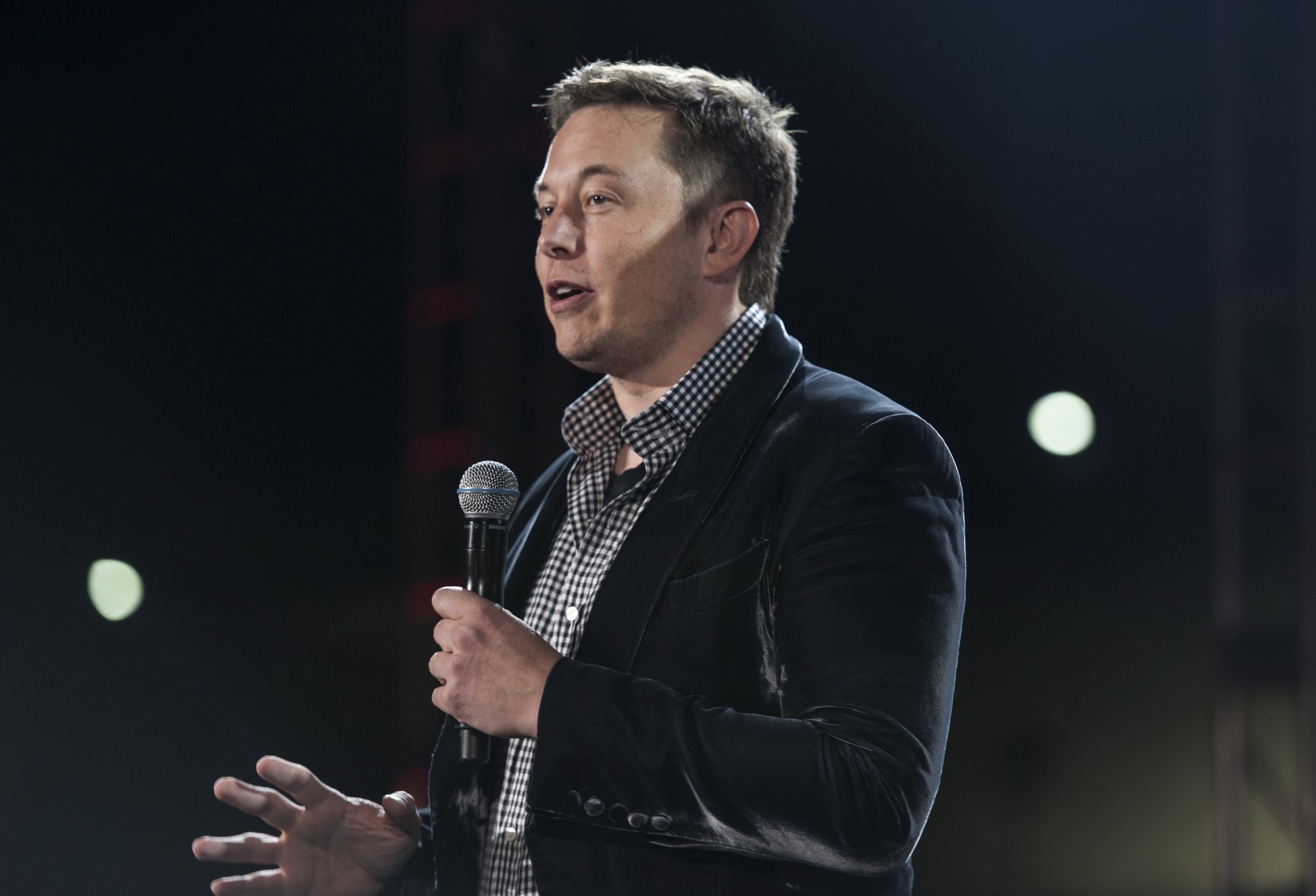 Electric carmaker Tesla Motors' CEO Elon Musk unveils the Tesla &quot;D&quot; an all-wheel-drive at the municipal airport in Hawthorne, Calif., on Thursday.