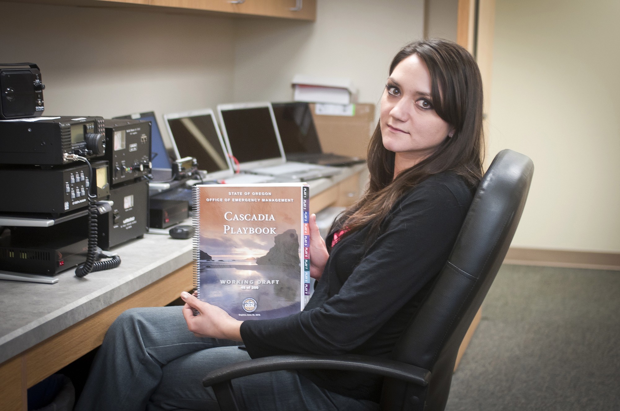 Kristy Bachamp, Wasco County Sheriff's Department emergency manager, holds a draft of the Cascadia Playbook developed by the Oregon Office of Emergency Management to plan emergency earthquake response.
