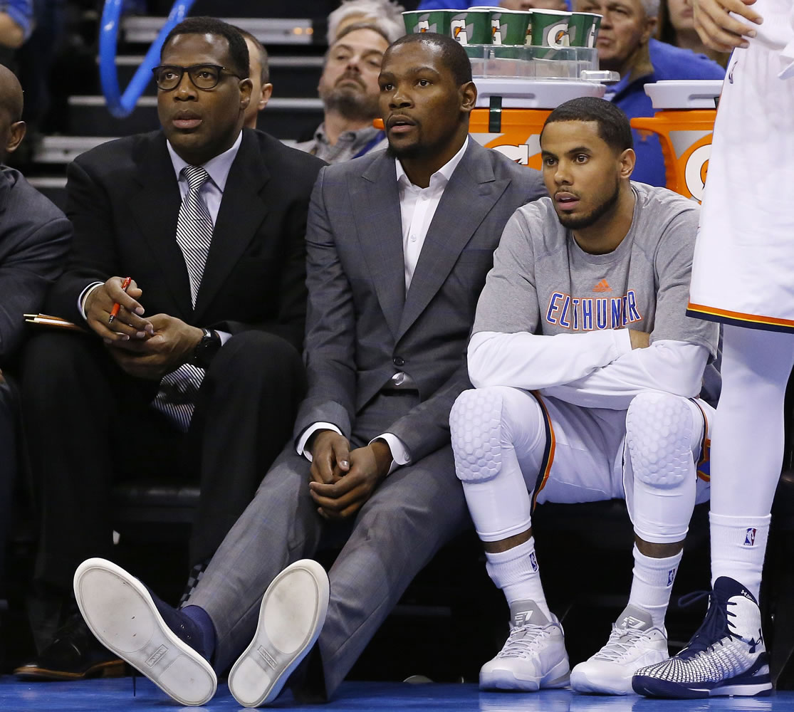 Injured Oklahoma City Thunder forward Kevin Durant, center, will have bone graft surgery next week to deal with a fractured bone in his right foot, and he will miss the rest of the season, the Oklahoma City Thunder announced Friday, March 27, 2015.