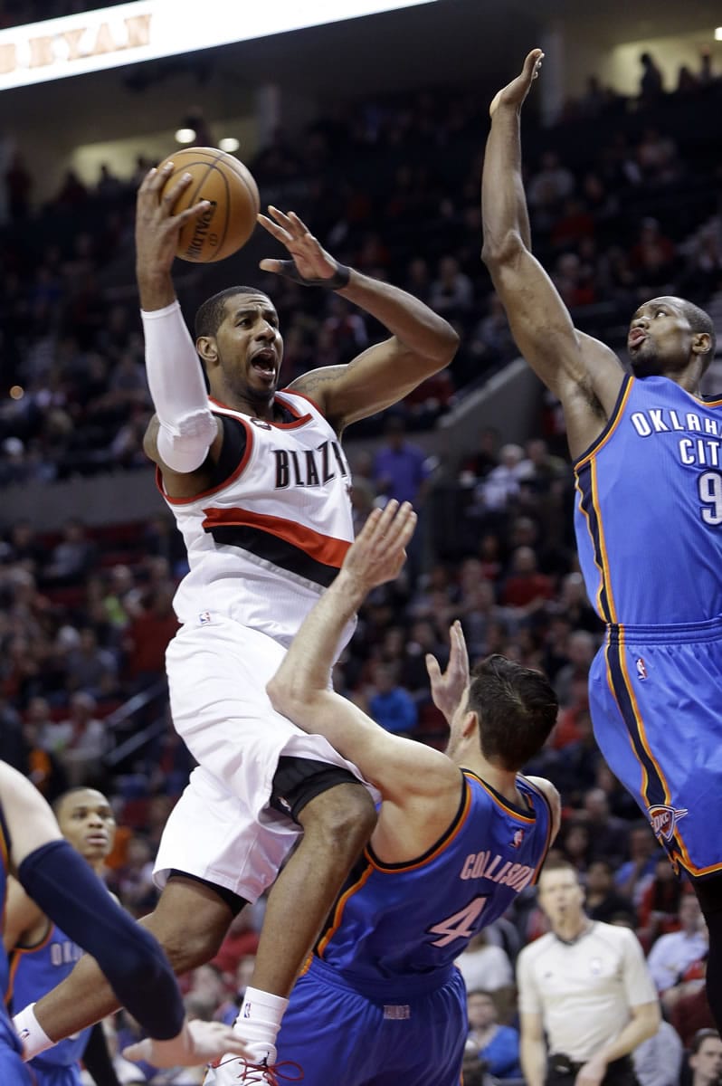 Portland Trail Blazers forward LaMarcus Aldridge, left, drives to the basket against Oklahoma City Thunder center Serge Ibaka, right, and Thunder forward Nick Collison during the second half Friday. Aldridge scored 29 points and pulled in 16 rebounds as the Blazers beat the Thunder 115-112.