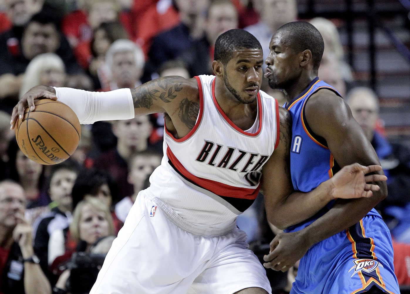 Portland Trail Blazers forward LaMarcus Aldridge, left, works the ball in on Oklahoma City Thunder center Serge Ibaka, from Congo, during the first half of an NBA basketball game in Portland, Ore., Wednesday, Oct.