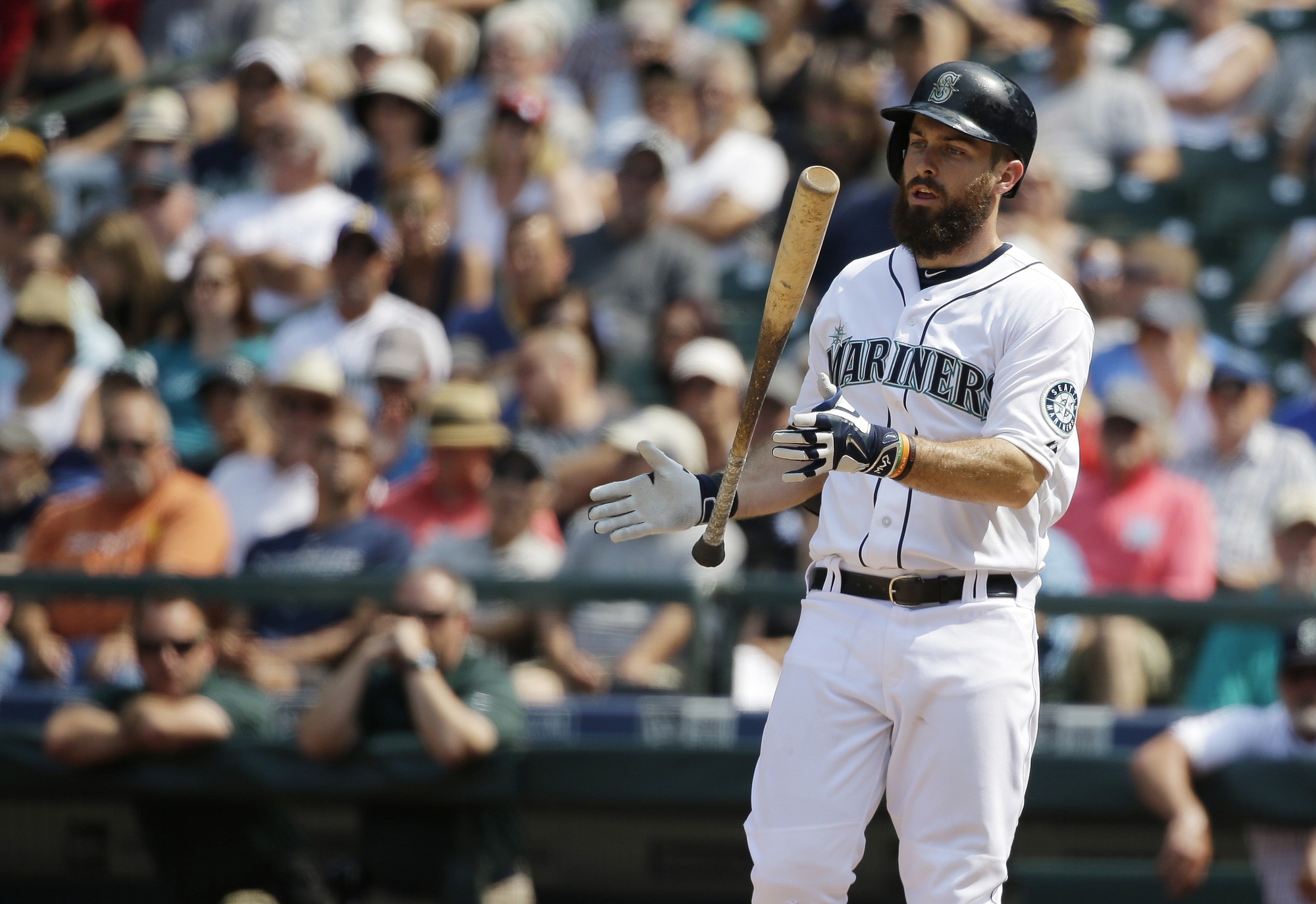 Seattle Mariners' Dustin Ackley tosses his bat after flying out in the seventh inning against the Detroit Tigers, Wednesday, July 8, 2015, in Seattle. The Tigers beat the Mariners 5-4. (AP Photo/Ted S.
