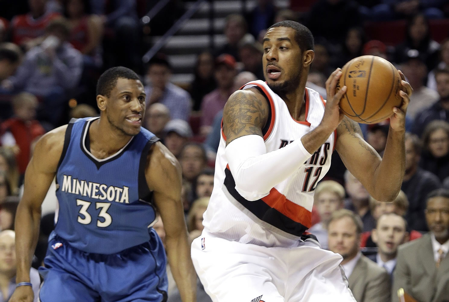 Portland Trail Blazers forward LaMarcus Aldridge looks for an opening as Minnesota Timberwolves forward Thadeus Young, left, defends during the first half Sunday, Nov. 30, 2014.
