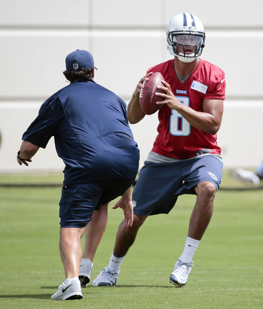 Tennessee Titans quarterback Marcus Mariota works on a drill with offensive coordinator Jason Michael during minicamp, Wednesday, June 17, 2015, in Nashville, Tenn. Mariota, the former Oregon star, is wrapping up his first NFL offseason in the Titans' three-day minicamp. It's been a hectic six weeks for the No. 2 pick overall as the quarterback works to learn as quickly as possible.