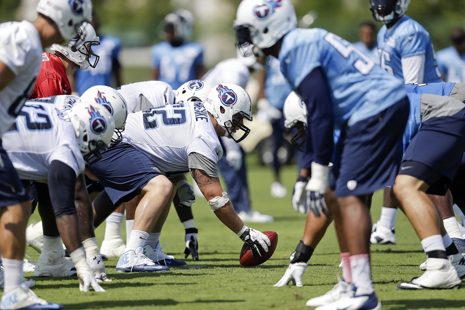 Tennessee Titans center Brian Schwenke (62), center, gets ready to snap the ball during NFL football training camp Saturday, July 26, 2014, in Nashville, Tenn.